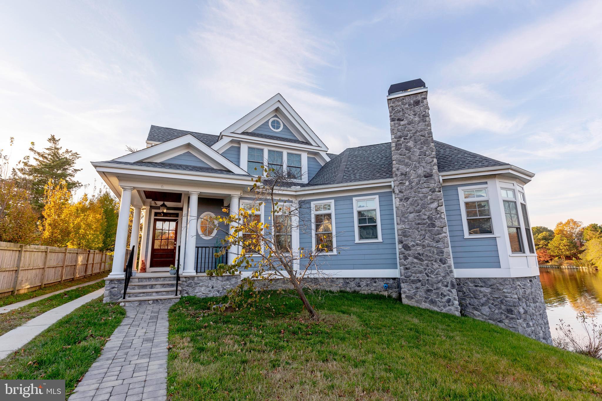 Beautifully designed and masterfully crafted waterfront home in Rehoboth Beach.  Welcome to 6 Silver Lane, with serene views from every angle. This one of a kind, custom home was designed to showcase the natural beauty of Silver Lake on every level. Colorful sunrises and picturesque sunsets greet from every room.  A spacious, open living area is the perfect backdrop, featuring stunning hardwood floors, sleek and modern gas fireplace and tray ceilings.  Enter into a gourmet kitchen with top of the line appliances, island and additional space for a bistro dining area with amazing views. A lakefront sunroom with deck access makes for a flexible dining area with plenty of room for entertaining guests or relaxing to the tranquil sound of wildlife on Silver Lake. The private 1st floor master bedroom features his & her closets, gas fireplace, and a beautiful bay window rising up above the lake. The lower level features a sizable bar, wine fridge, designer lighting and custom floors, with substantial unfinished space for storage. A full-sized elevator provides convenience with access to all 3 levels. The lower-level walkout patio features a leveled paver seating area with custom strand lighting.  .  All just steps to the beautiful Silver Lake bridge and downtown Rehoboth Beach.