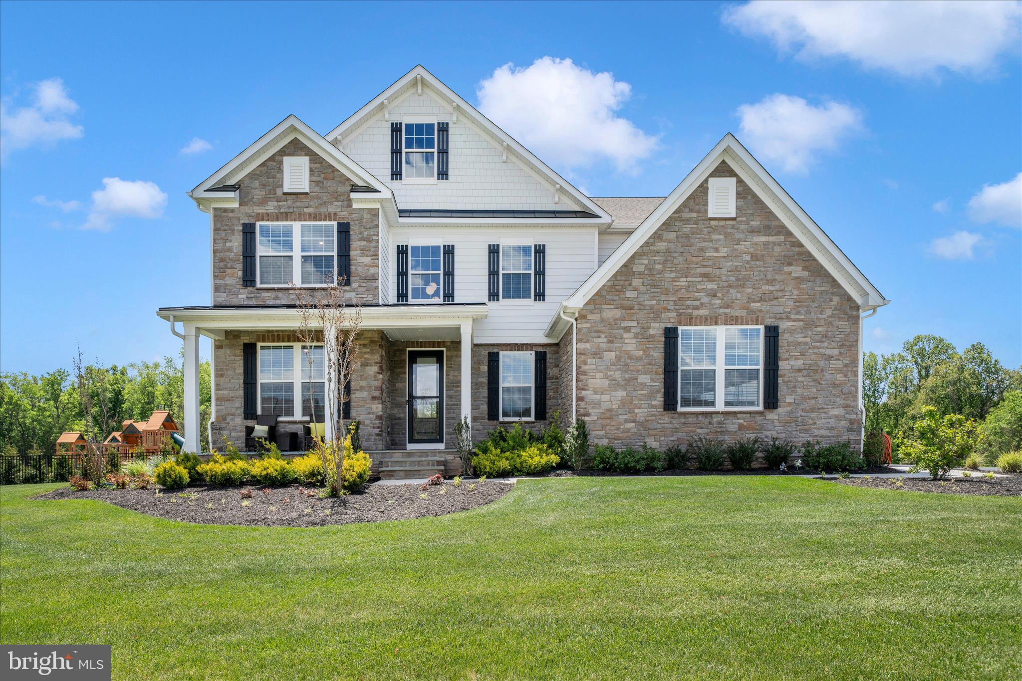 Country meets luxury living on this stunning private homesite offering over 6,000 finished square feet, including a 9-foot finished walkout basement and rare 4-car garage. The elegant Hampton model welcomes you with a grand two-story foyer, formal dining room, tray ceilings, and cozy fireplace.

The chef’s kitchen is designed for entertaining and everyday living, featuring double ovens, stainless steel appliances, a walk-in pantry, and abundant workspace. The finished lower level includes a spacious recreation room, hobby room, and full bath.

Oak stairs with iron balusters lead to the impressive upper level featuring 5 generously sized bedrooms, each with its own bath and walk-in closet. The luxurious primary suite offers a spacious sitting area with tray ceilings and a spa-inspired bath entered through French doors. Enjoy a breathtaking walk-through glass shower with dual shower heads, freestanding soaking tub, separate vanities with quartz countertops, soft-close cabinetry, private water closet, and two oversized walk-in closets.

Additional highlights include Mohawk RevWood flooring in the hallway, bedroom-level laundry room with cabinets and utility sink, and abundant storage throughout with multiple linen closets. This exceptional home combines elegance, comfort, and functionality in every detail.