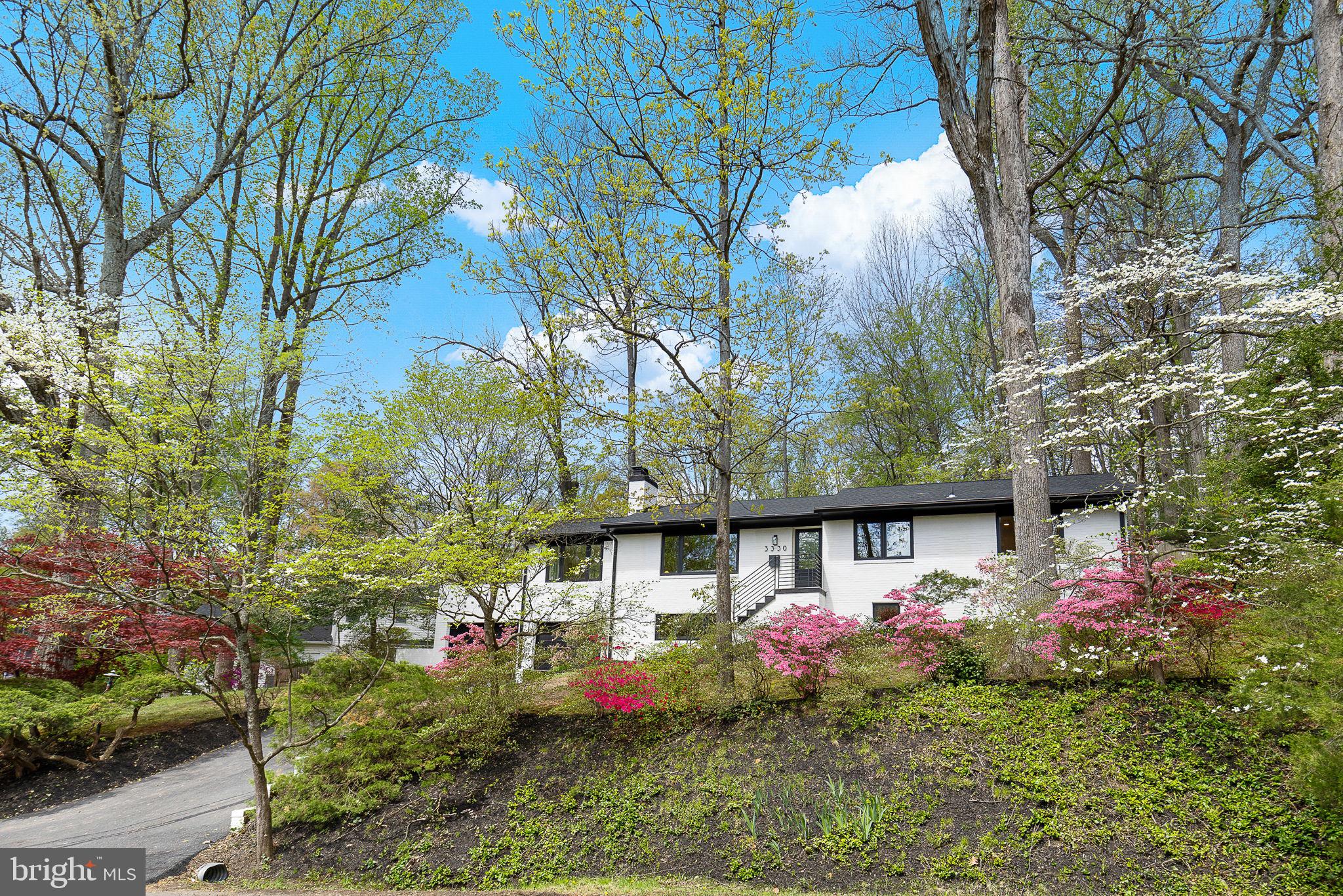 LAKE BARCROFT - This 4-bed, 3-bath  home is a showstopper! Stylishly renovated from top to bottom with fresh, modern finishes, sleek black windows throughout, and gleaming refinished hardwood floors on the main level.

Step into a welcoming living room anchored by a wood-burning fireplace with a granite surround and striking wood accent wall. The open-concept kitchen features a large island with breakfast bar seating, new LG stainless steel appliances, ample white cabinetry, black hardware, and table space. The adjacent dining room showcases new luxury vinyl plank flooring and is wrapped in three walls of windows that bathe the space in natural light. A French door opens to multiple patios and a beautifully landscaped backyard. 

The main level also includes three generously sized bedrooms and two fully remodeled bathrooms, both with dual vanities and stunning tile work. The spacious ensuite primary suite also offers a large walk-in closet.

The lower level boasts new luxury vinyl plank flooring and offers exceptional flexibility with a spacious family room with a wood-burning fireplace, a fourth bedroom, a stunning renovated full bath, and  bonus room — perfect for a home office, fitness room, or creative space. The oversized mudroom/laundry area offers abundant storage and direct access to the two attached garages.

Tucked on a quiet cul-de-sac, this half-acre lot is a private oasis, surrounded by mature trees and vibrant flowering shrubs. A spacious slate patio on the side and a flagstone patio in the rear offer relaxing outdoor settings. 

Located just blocks to Lake Barcroft's private beaches for swimming, boating, and fishing, this home also offers easy access to major commuter routes (50/66/395/495) and is just minutes to Tysons, Arlington, and Washington, DC

This thoughtfully reimagined home is a rare blend of style, comfort, and space. Whether you're a nature lover, a beach enthusiast, or just looking for a peaceful escape, this is your sanctuary in sought-after Lake Barcroft!

Owner/agent(s)