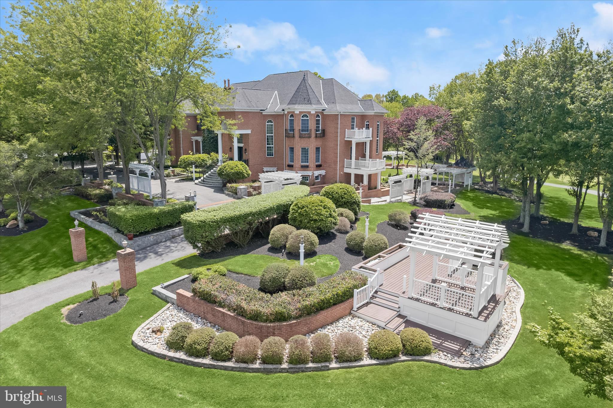 REFINED LUXURY; AN ARCHITECTURAL MASTERPIECE OVERLOOKING THE FAIRWAYSA rare architectural masterpiece overlooking the golf course, this extraordinary custom estate offers nearly 12,000 square feet of meticulously crafted living space where timeless elegance, exceptional craftsmanship, and grand-scale entertaining converge.
A dramatic two-story foyer welcomes guests with exotic hickory hardwood flooring, an impressive oval staircase, soaring ceilings, an oval recessed dome with cove lighting, extensive custom millwork, paneled walls extending to the ceiling, decorative niches, and walls of windows crowned by arched transoms. Throughout the home, architectural details abound, including arched cased openings, solid-core 8-foot doors, custom brackets and corbels, coffered ceilings, dentil molding, and exquisite craftsmanship rarely found in today's construction.
Designed for both gracious entertaining and everyday living, the central storied great room showcases a soaring two-story wall of windows framing picturesque golf course views, a richly detailed coffered ceiling, decorative niches, paneled ceiling accents, and dual Juliet balconies. The elegant living room features a distinctive turret-style design, arched openings with columns, and a decorative tray ceiling that enhances the home's sophisticated character.
The stunning two-story library is a showpiece unto itself, offering dual French-door entries, wood-paneled walls, a coffered ceiling, loft bookshelves accessed by a spiral staircase, and a Juliet balcony overlooking the space below.
The updated gourmet kitchen combines beauty and functionality with refreshed countertops, backsplash, and appliances, abundant workspace, and seamless access to the home's entertaining areas. Multiple HVAC systems, updated mechanical components, propane service, and a recently serviced septic system provide comfort and peace of mind.
Retreat to the luxurious primary suite, where a dramatic shaped tray ceiling, gas fireplace with custom mantel, wood wainscoting, arched architectural details, and transom windows create a private sanctuary.
Outdoor living is equally impressive with a barrel-vaulted front porch, pavilion, and expansive Trex deck designed to capture breathtaking golf course vistas and provide exceptional spaces for entertaining and relaxation.
The fully finished lower level elevates entertaining to another level with a full wet bar and full-service back bar, creating the perfect venue for gatherings large and small.
Blending old-world craftsmanship with grand architectural design, this remarkable estate presents a rare opportunity to own one of the area's most distinctive luxury residences. Come home to elevated living on the fourth hole and join the vibrant community Cattail Creek Country Club.