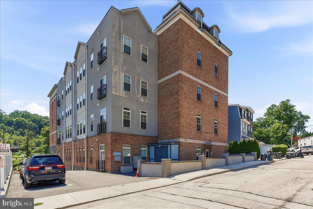 Welcome to effortless, low-maintenance living in the heart of Conshohocken! This beautifully constructed first-floor condo offers the largest floor plan in the community and is perfectly designed for modern living. Enjoy the convenience of two private parking spaces perfectly situated just steps from the entrance to the building.

Step inside to an open-concept layout filled with abundant natural light from the many windows throughout. The spacious living room flows seamlessly into the stunning kitchen, featuring timeless shaker-style cabinetry, quartz countertops, a stylish tile backsplash, and stainless steel appliances—ideal for entertaining or everyday living.

The thoughtfully designed floor plan offers two spacious bedrooms and two full bathrooms. The front primary suite features a generous walk-in closet and a private en-suite bath, creating a relaxing retreat. Toward the rear of the home, you'll find a second bedroom, an additional full bathroom, a convenient laundry area, and a utility/storage closet housing the HVAC system.

Luxury vinyl plank flooring extends throughout the home, offering both durability and contemporary style.

Located in the highly desirable Borough of Conshohocken, you'll enjoy easy access to Routes 76 and 476, SEPTA Regional Rail, and countless restaurants, breweries, shopping, and entertainment. Whether you're commuting to Center City or enjoying all that Conshohocken has to offer, this location is second to none.

Why wait for new construction? This move-in-ready home offers all the benefits of a brand-new build without the wait. Just unpack, move right in, and start enjoying maintenance-free living!