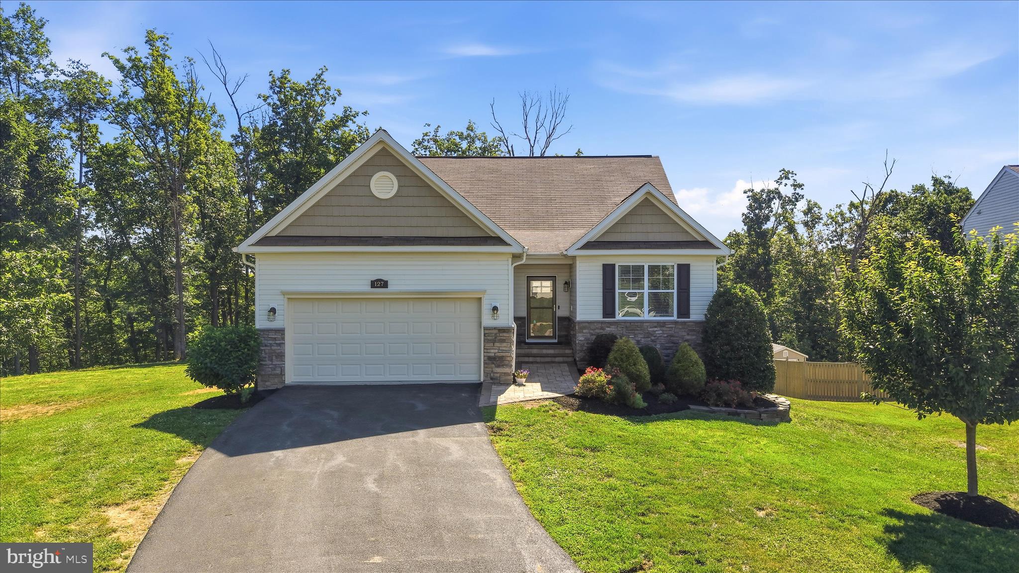 Welcome to Auburn Hill Ct where you will find LOTS of unexpected extra's!  This gem is situated on a fairly private cul-de-sac lot.  Open one level living with a fully finished basement.  On the main level you will find LVP flooring, 3 bedrooms and 2 full bath's and laundry.  Then there's the sunroom with direct access to the maintenance free large private deck that overlooks a wooded back drop.
Travel down to the large finished basement and discover another bedroom, full bath and large recreation room with doors out to the beautiful stone paver patio with a built in firepit!  If you need to get back to the kitchen quick you can take the spiral staircase right up to the deck.  The basement also has another large room with a closet that could be used as a bedroom but there is no egress so it can be whatever your heart desires!