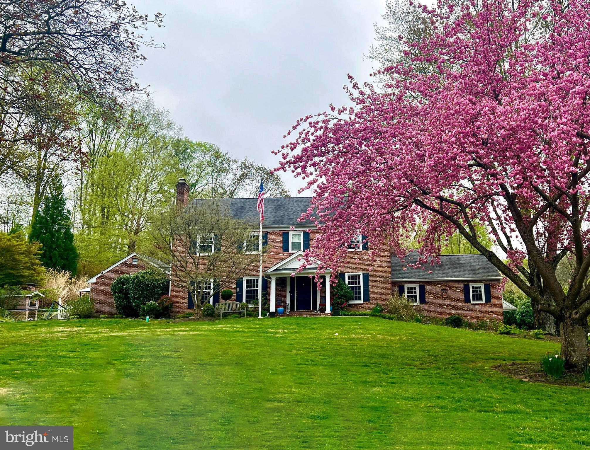 Welcome to Echo Valley in Newtown Square, an enclave neighborhood of homes on 1-2+ acre lots offering both community and privacy. Comfort and wow-factor define life at 334 Crum Creek Lane. Private grounds with curated gardens and trees create your own arboretum and botanical gardens. The expansive soapstone patio with bluestone sitting wall and handsome brick fireplace call for summertime s’mores while the authentic brick oven will be the centerpiece of amazing pizza parties. Varied landscape offers much enjoyment from soccer on the front lawn to backyard sledding, baseball, even practicing your chip shot. The driveway basketball court is great for players of all ages with the adjustable basketball hoop. Inside, the heart of the home is a show-stopping gourmet kitchen with extensive cherry cabinetry of the highest quality, custom built by Malvern-based DeRita Woodworking (who built all the kitchen/bath cabinetry). There is a 9’ island with exotic-grade granite, soapstone farmhouse sink, Wolf 5-burner propane cooktop, warming drawer, double ovens, and a cabinet or drawer for just about anything. A 12’ bench under the picture window provides seating for parties and additional storage. The impressive walk-in pantry and massive mudroom keep things organized where travertine floors and custom built-in cubbies make coat and shoe organization stylish. The roomy family room off the kitchen begs to host gatherings of all sizes. It features a brick fireplace, beamed ceilings, and beautiful picture windows. In the front of the home on either side of the foyer are formal living and dining rooms. Glass doors were added to the living room for privacy. A bonus room connects the living room, patio, and game room. Dutch doors open into the impressive game room with cathedral ceilings. This flex space has many potential uses and could be transformed into a first floor bedroom suite (plumbing in wall behind bonus room closet). The formal powder room features a tiger maple vanity with stunning granite and a travertine floor. Upstairs the grand primary bedroom suite offers panoramic views, a walk-in closet/dressing room, and a fabulous bath. Standout details of the all-marble bathroom include mosaic tile detail, honed marble counters, a plethora of storage, and an oversized shower. The largest of the secondary bedrooms has a custom fitted closet, built-in bookshelves, and door to the full bath. The third and fourth bedrooms are generous in size with good closet space and beautiful views. Completing the second floor is a full bath with quartz counters, Eucalyptus wood cabinets, and white subway tile with onyx mosaic tile. A walk-up attic hosts the second HVAC system and tons of storage. It could be finished for a variety of uses. The basement of the home is finished, just awaiting your touches on flooring and trim. It offers large rec spaces, a workshop, two sets of laundry hookups, and access to a 3-car garage. Noteworthy features from the renovation include baseboard heat conversion to forced air, 2-system with 4-zones, buried 1000 gal propane tank, upgraded plumbing and electrical, architectural-grade shingle roof, tankless water heater, new gutters w/gutter guards, and so much more. No expenses were spared renovating and maintaining this stunning home. Quality and style will carry the next lucky owners through many years of enjoyment. Echo Valley has informal association with regular gatherings and events. Throughout the neighborhood you will see neighbors walking dogs, bikes, strollers, and homeowners tending to their gardens. Minutes from shopping, restaurants, prestigious private schools including Episcopal Academy, renowned golf courses including Aronimink, White Manor and Overbrook, and located in award-winning Marple Newtown SD. It’s a quick commute to the train, airport, Main Line and many business parks. The home has been pre-inspected, so all the new owners need to do is unpack and move right in.
