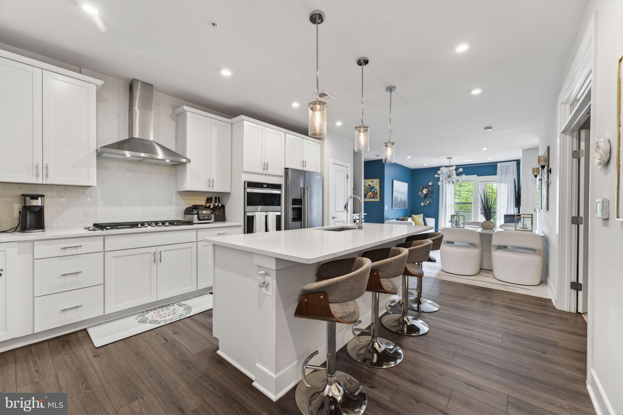 Welcome to exceptional living in the heart of National Harbor. This beautifully designed 2-bedroom + den, 2-bath residence at 102 St Ives Place #305 offers approximately 1,425 square feet of bright, open-concept space within one of the region’s premier waterfront communities.
Step inside to a spacious, light-filled layout with ideal bedroom separation and a central living area designed for both comfort and entertaining. The heart of the home is a stunning gourmet kitchen featuring an oversized island, sleek quartz countertops, stainless steel appliances, and abundant cabinetry—perfect for hosting or everyday living. The kitchen flows seamlessly into expansive living and dining spaces that open to a private balcony overlooking a quiet, tree-lined setting.
The primary suite is thoughtfully positioned for privacy, offering a generous footprint, en-suite bath, and excellent closet space. On the opposite side of the home, the second bedroom provides an ideal setup for guests or shared living.
A standout feature is the dedicated den/office with French doors and a built-in Murphy bed—creating a flexible third sleeping area, executive home office, or private retreat.
Additional highlights include in-unit laundry, a separate utility/storage area, and one assigned garage parking space.
Set within National Harbor, this residence offers true walkability to the waterfront, marina, acclaimed dining, shopping, and year-round entertainment. Enjoy scenic promenades, vibrant community events, and the dynamic energy of waterfront living just outside your door, with convenient access to Washington, DC, Northern Virginia, and major commuter routes.