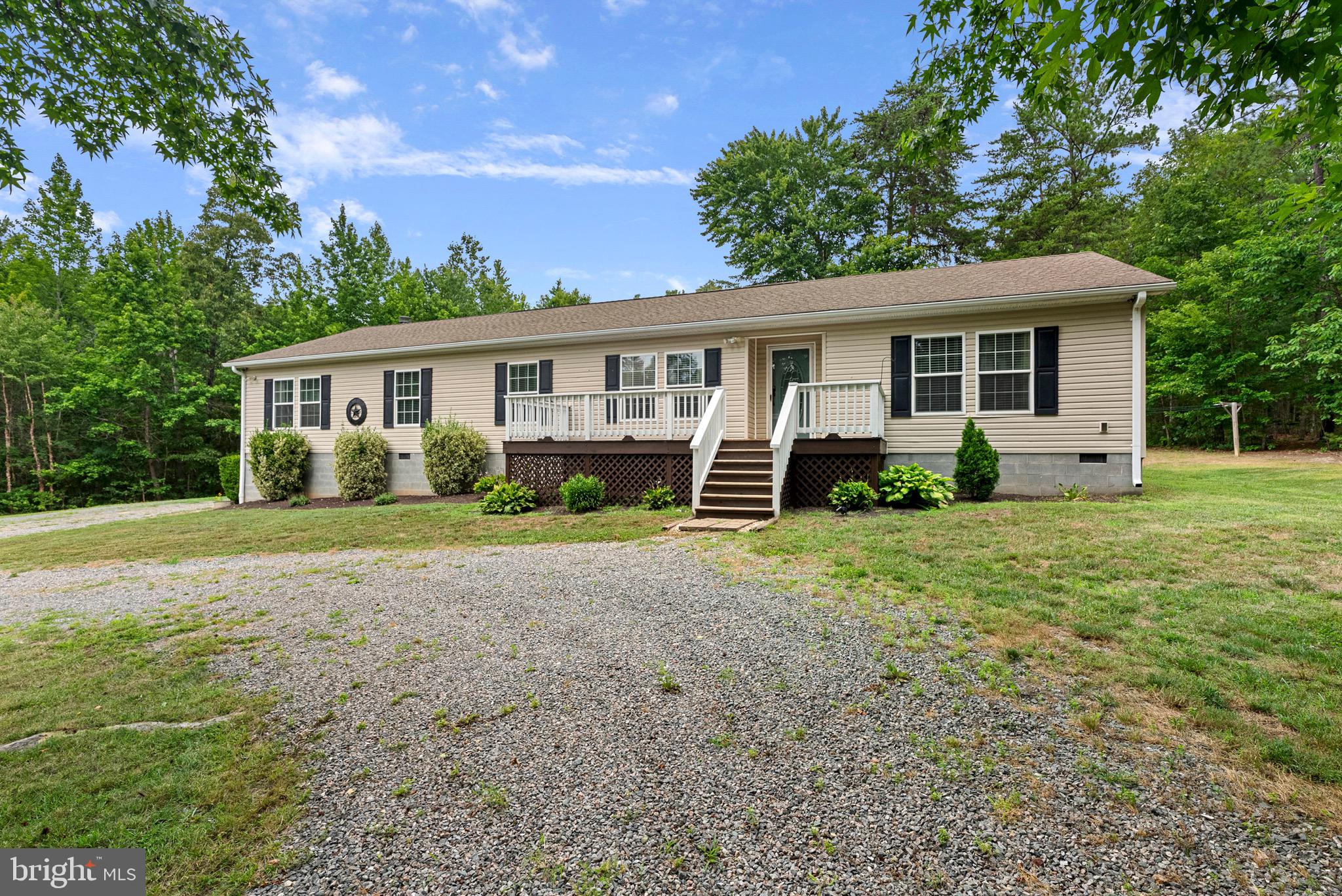 Tucked away among the trees on nearly 4 private acres, this beautifully maintained ranch home offers the perfect blend of comfort, privacy, and charm. From the moment you arrive, you'll appreciate the peaceful setting and the meticulous care that has gone into every detail of this property. Inside, you'll find warm and inviting living spaces, including a cozy living room with a wood-burning stove and a spacious den featuring a fireplace—perfect for relaxing with family or entertaining guests. The large primary suite provides a peaceful retreat with a private bath complete with a soaking tub. The kitchen has been tastefully remodeled within the past year and a half and features stunning granite countertops, updated cabinetry, and modern finishes. New flooring installed throughout the home during the same timeframe adds a fresh, cohesive feel. Built-in bookshelves provide both character and functionality, creating the perfect space to display your favorite books and décor. Situated in a desirable area, this home offers the tranquility of country living while remaining conveniently located to nearby amenities. Whether you're enjoying your morning coffee surrounded by nature or unwinding by one of the two cozy heat sources, you'll love calling this exceptional property home. If you've been searching for a move-in-ready home with acreage, privacy, and timeless appeal, this one is a must-see!