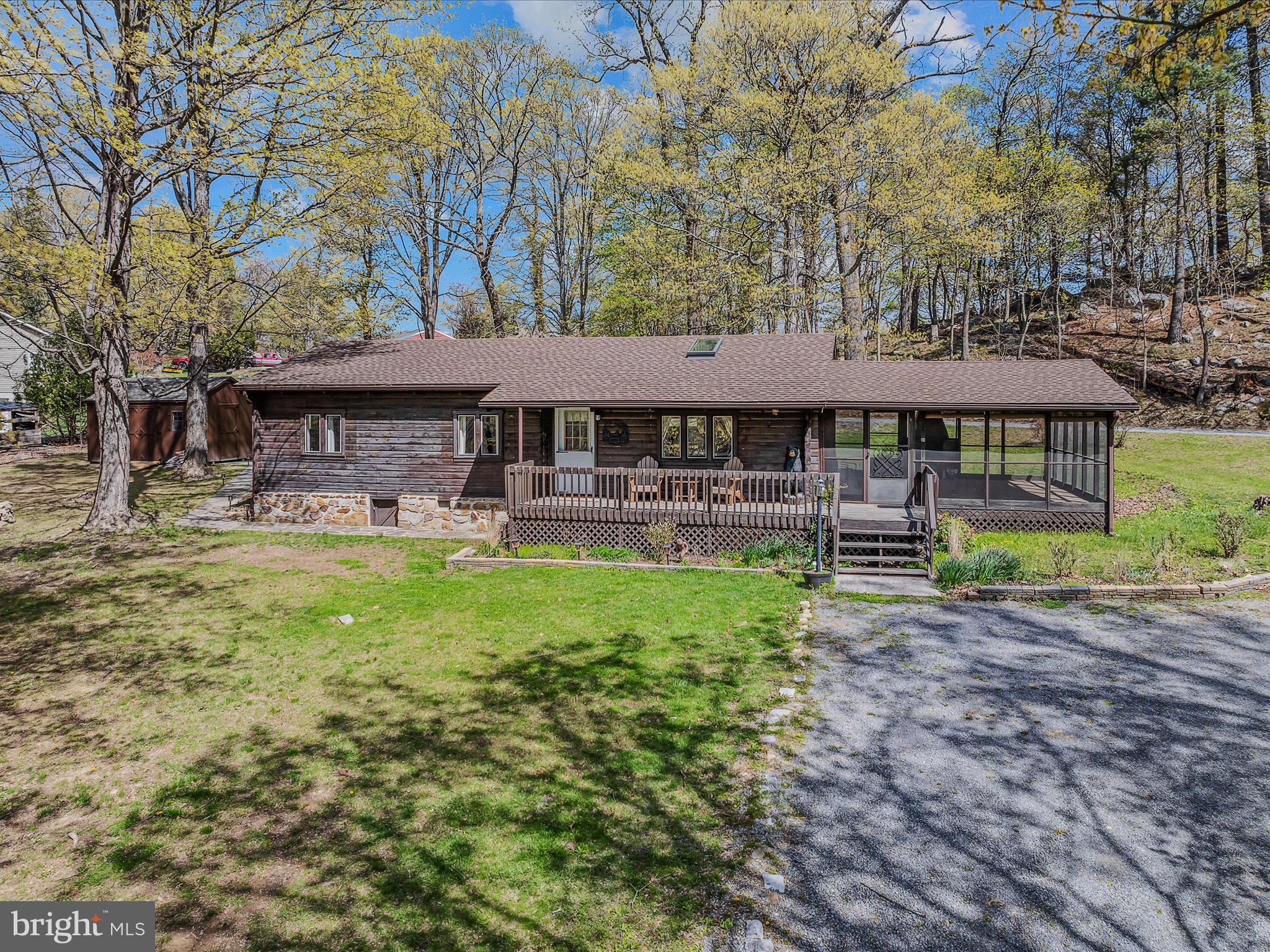 Just around the corner from downtown Berkeley Springs on 2.08 UNRESTRICTED acres-think Airbnb or home business possibilities!  This delightful log home features a beautiful recent kitchen remodel that opens the floor plan of living and dining to bring everyone together.  Living room features an electric stone fireplace for that cozy ambiance.  Three bedrooms and one bath with updates rounds out the warm home interior. A charming enclosed screened porch will entice you to entertain with a sprawling 500 sq ft of space and includes an outdoor stone fireplace to grill in!  Perfect to use 3 seasons of the year.  Plenty of space in the yard to add a garage or a nice outdoor seating area around the fire pit.  All this just a minute from dining, shopping, breweries, spas and amenities of Berkeley Springs State Park and downtown.  Cacapon State Park just 10 miles south for swimming, hiking, biking, tennis, boating, horseback riding and golfing.