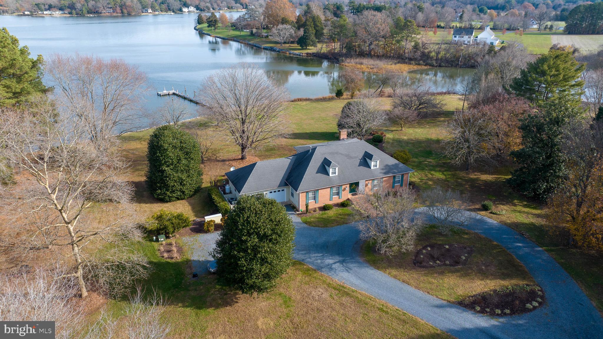 Nestled on a sprawling 5-acre parcel with an ​impressive 450 feet+/- of shoreline, this ​stunning home offers the perfect blend of ​luxury and tranquility. With 3 bedrooms and ​3 bathrooms, this waterfront oasis ​promises a lifestyle of comfort and ​sophistication. Open floor plan seamlessly ​integrates the kitchen, dining area, and ​family room. Updated kitchen is a chef's ​delight, featuring sleek stainless steel

appliances and elegant Silestone countertops. This space is not only functional but ideal for entertaining ​family and friends. The desirable main-level primary suite with en-suite bathroom and direct access to the ​back deck with gorgeous water views. Second floor landing with built-in bookcases is a versatile space that ​can serve as a cozy reading nook, home office, or a showcase for your cherished literary collection.

Step outside and experience the panoramic views of the water and surrounding landscape that make this ​property truly special. A private pier extends into the water, providing direct access for boating, fishing, or ​simply enjoying nature.