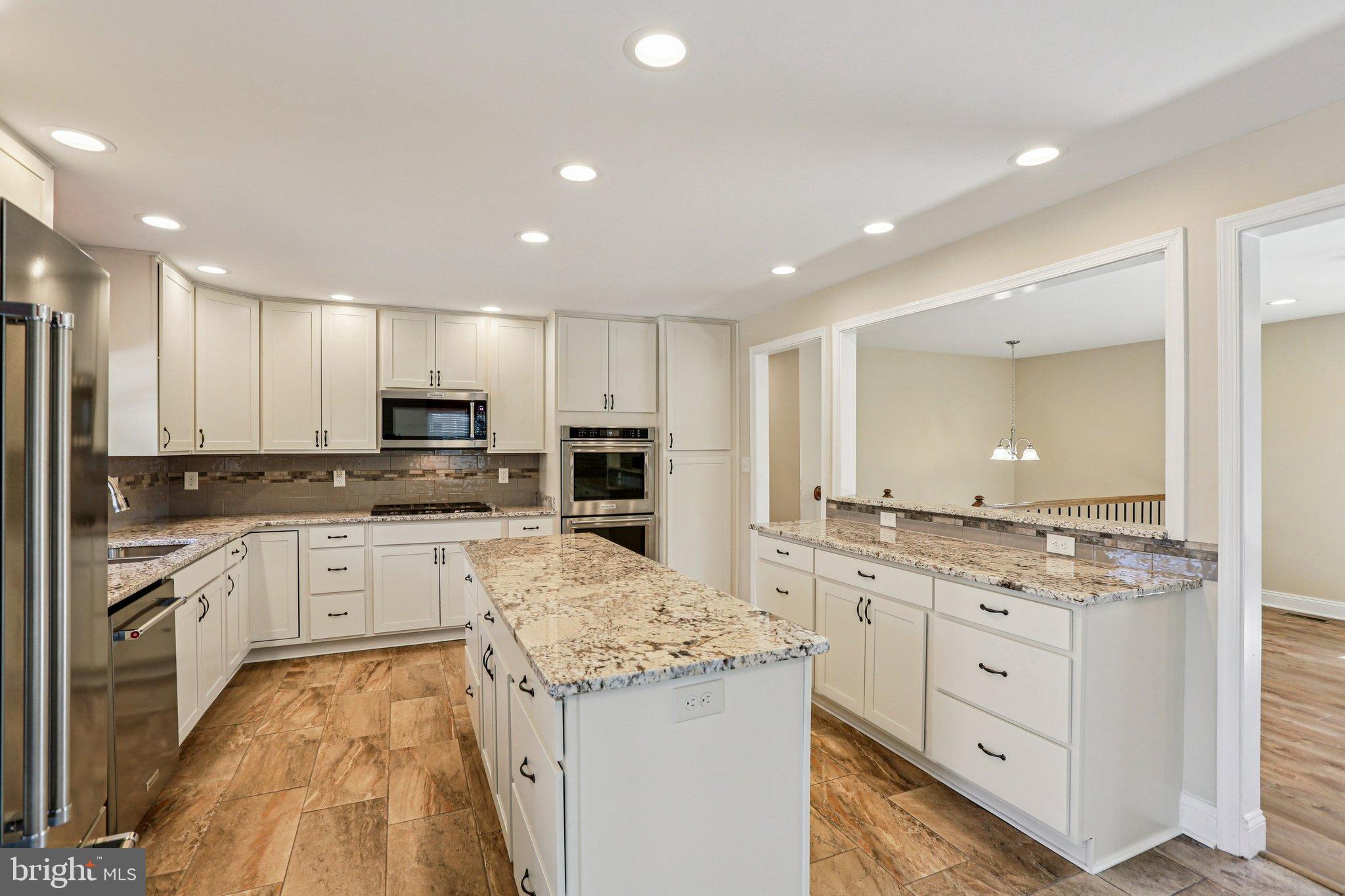 Nestled in the charming Selby Grove community, this stunning split foyer home has undergone a major renovation in 2022, blending modern luxury with timeless comfort. With 2,352 square feet of thoughtfully designed living space, this residence offers an exclusive lifestyle that caters to both relaxation and entertainment. As you step inside, you are greeted by an inviting atmosphere that seamlessly combines elegance and warmth. The heart of the home features a spacious living area adorned with a cozy gas fireplace, perfect for gathering with loved ones on chilly evenings. The open layout flows effortlessly into the dining area, where natural light pours in, creating a bright and airy ambiance. The gourmet kitchen is a chef's dream, boasting high-end appliances, sleek countertops, and ample cabinetry. Whether you're preparing a casual meal or hosting a lavish dinner party, this kitchen is equipped to handle it all with style and sophistication. This home offers four generously sized bedrooms, providing plenty of space for relaxation and privacy. The luxurious bathrooms, including three full baths and one half bath, have been meticulously updated with modern fixtures and finishes, ensuring a spa-like experience at home. The fully finished basement adds an extra layer of versatility, perfect for a media room, home office, or play area. With its thoughtful design, this space can adapt to your lifestyle needs, making it an ideal retreat for both work and play. Step outside to discover a serene half-acre lot, offering a peaceful escape from the hustle and bustle of daily life. The outdoor space is perfect for summer barbecues, gardening, or simply enjoying a quiet moment in nature. Located in the desirable Selby Grove neighborhood, this home is not just a residence; it's a lifestyle. Enjoy the convenience of nearby amenities while relishing the tranquility of suburban living. With its luxurious renovations and inviting charm, this property is ready to welcome you home. Experience the perfect blend of comfort and elegance in a space designed for modern living.