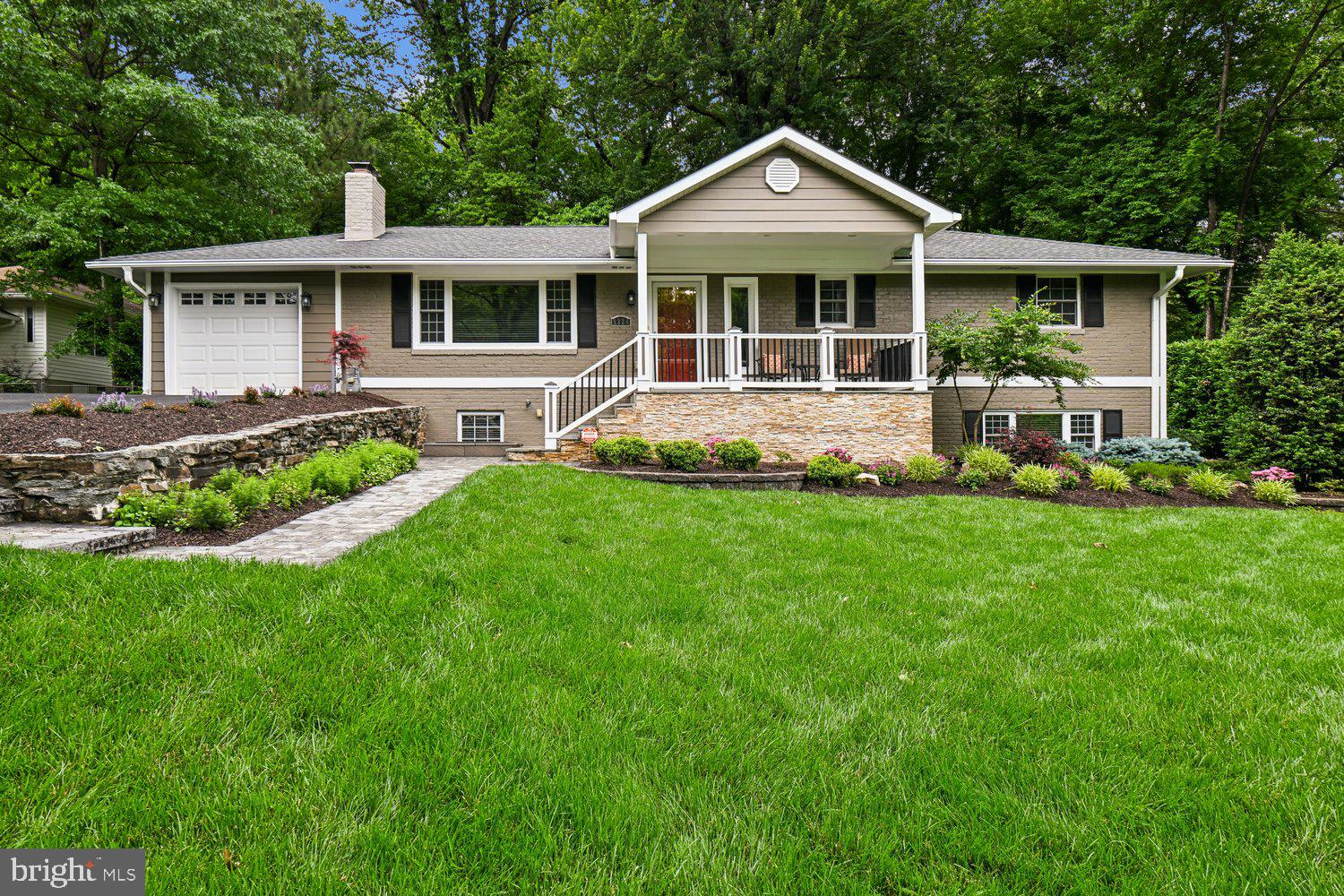 Nestled at the end of a quiet dead-end street on a beautifully maintained 0.51-acre wooded lot, this 4-bedroom, 3-bath full-brick residence offers exceptional privacy in a serene natural setting. Framed by strong curb appeal and a welcoming front porch, the home makes an immediate impression of quiet distinction and retreat-like living.

Comprehensively renovated in 2015, the home underwent a complete interior transformation along with extensive system upgrades, including electrical, plumbing, HVAC, ductwork, roof, windows, and water heater. Thoughtful exterior enhancements further elevate the property, including a new asphalt driveway (2017), charcoal paver walkway (2026), LeafGuard gutter system (2017), and professional landscaping. UV-protected window tinting enhances comfort and efficiency, while the full brick exterior provides lasting durability and timeless architectural presence.

Approximately 2,498 square feet of light-filled living space showcases wooded views throughout, creating a seamless connection to the natural surroundings. Expansive windows frame the landscape and enhance the home’s sense of openness, warmth, and calm.

The primary suite serves as a private retreat with soft natural light and tranquil views. The fully renovated primary bath (2021) features a glass-enclosed shower and modern finishes, offering a spa-like experience.

Hardwood floors, custom wood blinds, two fireplaces, integrated surround sound, and curated finishes create a warm yet elevated interior designed for both everyday living and effortless entertaining.
The lower level offers exceptional versatility, ideal for a guest suite, in-law suite, or multigenerational living, with additional space for a recreation area, home office, fitness room, or media room.
Outdoor living is anchored by a spacious flagstone patio overlooking the wooded backyard—perfect for quiet mornings, outdoor dining, and evening gatherings.

Additional highlights include a built-in irrigation system and recent appliance updates: refrigerator/freezer (2021), dishwasher (2021), microwave (2025), and LG washer/dryer (2026), along with recent interior and exterior painting.

Located within the highly sought-after Woodson High School pyramid, the home offers convenient access to commuter routes, shopping, dining, and everyday amenities.

A rare opportunity to enjoy refined wooded privacy, comprehensive modernization, and everyday convenience in a home that feels both timeless and increasingly difficult to find.