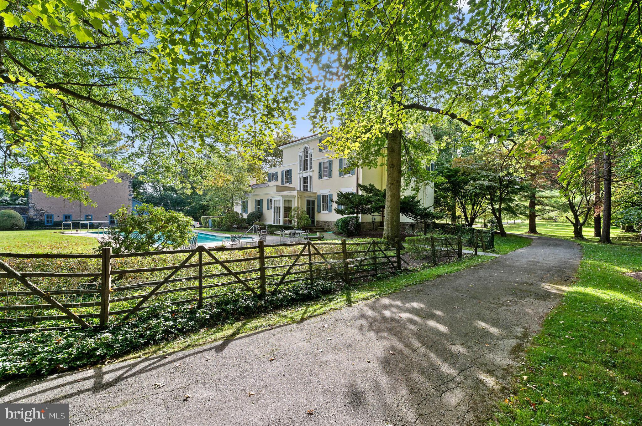 "Kimberlea" stands as a timeless masterpiece set on a sprawling 5-acre estate in Gladwyne, adjacent to the 9th hole of the Philadelphia Country Club.  Built in 1832, this iconic estate property is ready for a transformative new chapter. The expansive grounds, once dedicated to equestrian pursuits, now boast mature trees, specimen plantings, and panoramic views, creating an ambiance rich in history and potential.

The main residence, characterized by Federal style architecture, seamlessly blends old-world charm with modern possibilities. The inviting living room, complete with a fireplace and library nook, and French doors open onto a tranquil patio. The grand dining room flows into a butler's pantry and an eat-in kitchen overlooking a peaceful swimming pool. The residence has a recently updated 7/8 inch cedar shake roof.

Upstairs, the second floor reveals three spacious bedrooms with fireplaces and two baths, while the third floor offers four additional bedrooms and two baths. These spaces can easily transform into study rooms or creative spaces for crafts and gift-wrapping.

While "Kimberlea" has been lovingly maintained and doesn't require immediate restoration, it is indeed a BIG project ready to be shaped by ambitious visions. The sellers welcome offers from buyers eager to infuse their personality into this grand estate.

Imagine transforming the historical stone bank barn into a lively Party Barn, complete with indoor pickle ball, half-court basketball, and a movie/play room. The vast property has ample space for a tennis court and putting green, promising five acres of fun and leisure. The kitchen, not part of the original structure, can be expanded towards the barn, creating an open-concept family room with an attached garage. The carriage house presents opportunities for a secluded home office, private gym, or an in-law cottage.

The living room, traditionally formal, can be re-imagined to include a library and a pool table, creating a space for relaxation and entertainment. 

"Kimberlea" is a unique opportunity for those who are passionate about crafting a home tailored to their desires. Located close to award-winning schools and major transportation routes, and imbued with the esteemed ambiance of the Philadelphia Country Club, this estate is a canvas for dreams.