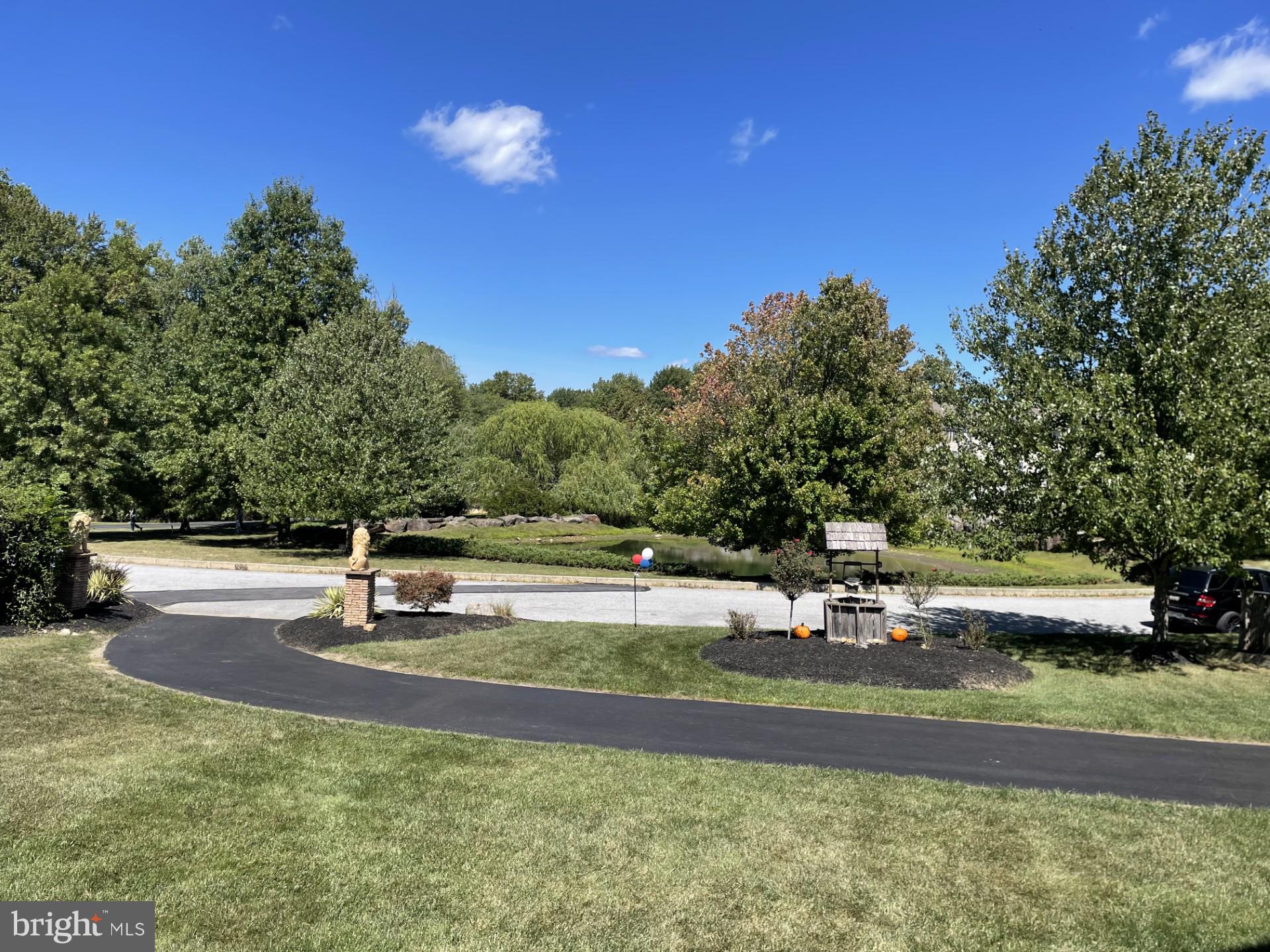 Spectacular is an understatement; one of a kind former Pondview model home nestled on a premium .9 acre private level lot looking out over a beautiful pond across the street, situated in the heart of Garnet Valley and top rated Garnet Valley school district.  A beautiful grand stone facade and main front entrance walks into a breathtaking cathedral foyer entrance where you're greeted by endless upgrades & top end finishes including endless custom millwork, custom stonework, gleaming wood floors that flow throughout a lovely open floor plan, 10' ceilings and much, much more.  Only available due to downsizing/relocation, this fabulous upgraded and lovingly maintained home has 5 spacious bedrooms on the upper level with private access to 4 full baths and every closet is fitted with custom closet organizers.   The luxurious master suite is exceptionally spacious; featuring a pan ceiling, crown moulding, a large sitting room, two large walk in closets with custom built in organizers, and a fabulous tiled master bath with with an oversized  walk in tiled rainfall shower, his & her double vanity and a separate water closet. For optimum convenience the laundry is also situated on the upper level.   The main level living area features a spacious family room with a cozy fireplace that is adjacent to the gourmet kitchen with beautiful upgraded Century cabinetry, an oversized center island, a large pantry, custom millwork and custom stone accent wall, crown moulding, stainless appliances including double ovens, microwave, dishwasher and cooktop, a vented hood and a commercial grade sub zero refrigerator, lovely double thick granite counters and a beautiful sunny morning room featuring a vaulted ceiling that walks out to a rear deck looking out over the large private rear yard backing to trees and nature abounds.   Also adjacent to the kitchen is a grand formal dining room and living room suite with a lovely wood burning fireplace, crown moulding, chair rail, farmhouse wall panel, and there is a spacious private office with a bay window looking out over the front yard and a lovely pond across the street, a conveniently situated half bath and a mudroom with a large coat closet that has custom built organizers leading to the two garages for three cars and all your toys. There is even a custom sport court and basketball hoop outside for the sports enthusiast.   The finished lower level adds another 1,592 square feet of stunning finished living space with a great room featuring a fantastic built in granite wet bar, custom stacked stone and distressed pallet accent walls,  a professional grade theater with a 110" screen and state of the art projection and sound system as well as tiered leather theater seating, and a full bath, plus unfinished storage / utility rooms and an exercise room (not counted as finished space).  Centrally located to the Garnet Valley School campus, the Concord Township Park, Walking & Running Trails, Dog Parks, Rachel Kohl Library, the Brandywine Youth Club sports fields and field-house, dance studios, Darlington Arts Center & all commuting routes to corporate centers, Delaware tax free shopping, airports, Philadelphia, Wilmington, Media, West Chester & more.   This exceptional well maintained home is a must see and is truly move in ready.  Showings begin Sunday September 8th; schedule a tour of this spectacular home today or come to the open house scheduled for Sunday September 8th from 12 PM to 4 PM.