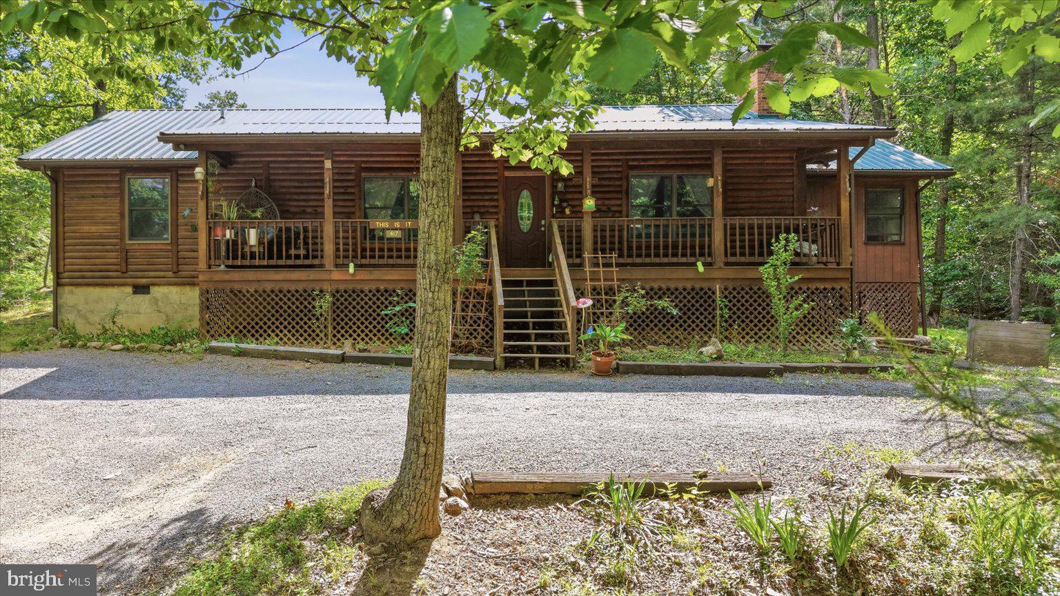 Tucked on a level lot at Bryce Resort, this one-level log-sided home offers the perfect blend of mountain charm and easy living. Inside, you’ll find an open living and kitchen area with vaulted ceilings, warm wood accent walls, and a propane fireplace that creates a cozy retreat year-round. Just off the kitchen is an oversized bonus sunroom offering incredible flexibility for an additional living area, large dining space, game room, or even a future fourth bedroom.

Finishing out this one-level living home are 3 bedrooms, 2 full bathrooms, a laundry room with access to the back yard, and a walk-in pantry for added convenience. Major updates were completed in 2022 including a new metal roof, HVAC system, and appliances.

Outside, the home continues its mountain-lodge feel with a large covered front porch perfect for relaxing and enjoying the peaceful setting. The property also offers ample level parking, a rarity for many mountain properties within Bryce Resort.

Schedule your tour today! 
*Furnishings can convey