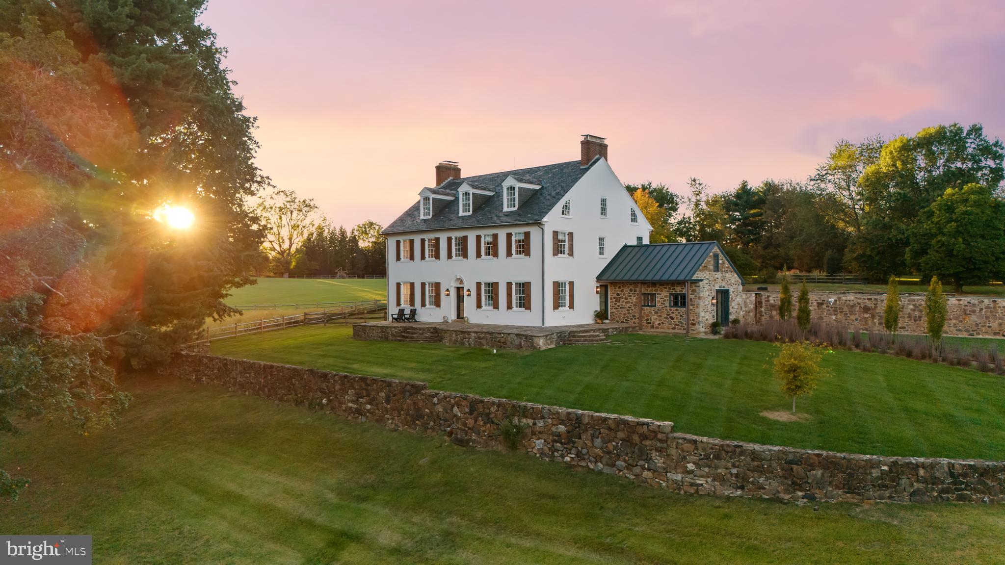 Rooted in the traditions of Chester County’s early Quaker homesteads, this remarkable property dates to 1699 and is surrounded by hundreds of acres of conserved open space and walking trails.
 
The main house has been thoughtfully reimagined to align with today’s aesthetics while preserving its historic integrity and exceptional craftsmanship. The owner, a highly respected designer, carefully leveraged the home’s orientation, long pastoral views, and abundant natural light to enhance the home’s original architectural character. Original floors were refinished rather than replaced, reinforcing authenticity. Select walls were removed on the main level to create a more open and gracious flow. What was once a smaller kitchen and dining area has been joined to form a generous family room anchored by a striking, impeccably designed kitchen. Similarly, the former parlor and music room are now combined to create a bright and expansive living and dining space. The family entry—finished with large-format Belgian bluestone floors and custom cabinetry—elegantly doubles as an independent dining room for hosting larger gatherings. The second floor features three ensuite bedrooms. The primary suite includes a walk-in closet, a custom bath with steam shower and thoughtfully selected fixtures. Two additional bedrooms, each with their own bath and reach-in closets, retain their original fireplaces for charm and historical resonance. A traditional staircase leads to the third level—left unrenovated because the space was not needed by the current owners. With high ceilings, existing plumbing, and an expansive open footprint, it presents an ideal opportunity for an additional two bedrooms and bathroom as well as an adjoining sitting room.
 
Attached to the three-car garage is a two-story stone barn built in 1804. The first floor is finished as a guest or au pair suite and the second floor, accessed by a separate entrance, is ready to be finished as another living suite.
 
Further down the private drive, at the entrance of the property, is a beautifully renovated post-Civil war Victorian house which features five bedrooms and two and half bathrooms. A renovation of the third floor would offer three more bedrooms and another bath.
 
Directly across Grubbs Mills Rd is the 102-acre Kirkwood Preserve with magnificent walking trails and unparalleled views of the surrounding horse farms and open fields. 
 
Completing the property is an extraordinary stone bank barn—among Chester County’s most significant in both scale and architectural importance. The historic three level barn is ready for a creative renovation, while the finished lower level houses a renovated professional woodworking shop with heat and ac, studio lighting and 220V power.
 
In every respect, this property has been transformed by its current stewards—artfully, carefully, and with deep reverence for both past and future. It is a rare and meaningful estate, and one the original owners would undoubtedly recognize with pride. Simply extraordinary.