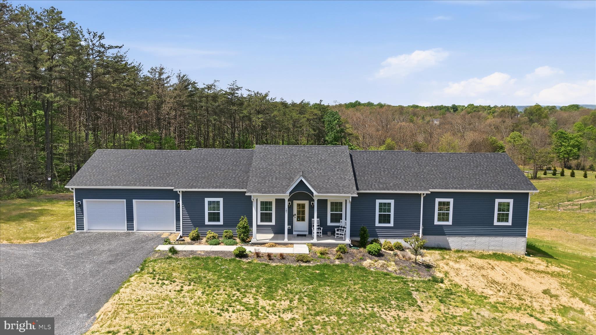 Tucked at the back of the subdivision, this 2020-built home sits on a generous two-acre lot with no HOA, where the backyard quietly gives way to a wooded tree line, a natural backdrop you'll never tire of.  Whether you're sipping coffee on the private deck at sunrise or unwinding by the fireplace on a cool evening, this home is easy to love.
The heart of the home is an open eat-in kitchen and family room with a floor to ceiling electric fireplace designed for real life — a large island anchors the space, there's room for a full eat-in dining area, and the flow to the deck makes indoor-outdoor entertaining effortless. A dedicated laundry and mudroom keeps the everyday organized right from the moment you walk in the door.
When the day is done, everyone has their own retreat. Two bedrooms and a bonus room share a well-appointed hall bath. A princess suite offers privacy with its own ensuite, ideal for guests, extended family, or someone who simply wants their own space. And then there's the primary suite: a genuine sanctuary, with a generous walk-in closet with custom built-ins, a soaking tub for unwinding, and a glass-enclosed shower that feels spa-caliber. This is the suite buyers dream about.
Downstairs, a finished home office sits within an otherwise open, unfinished walkout basement, room to grow into however fits your life. An attached shed/garage out back adds handy utility space, ideal for a ride-on mower, garden tools, or weekend projects. And because the community allows RV parking, you have the lot space to make that work without giving up your yard.
With quick access to I-81 and an easy drive down Route 45 to Winchester, the location checks every box, without sacrificing a single acre of peace and privacy.