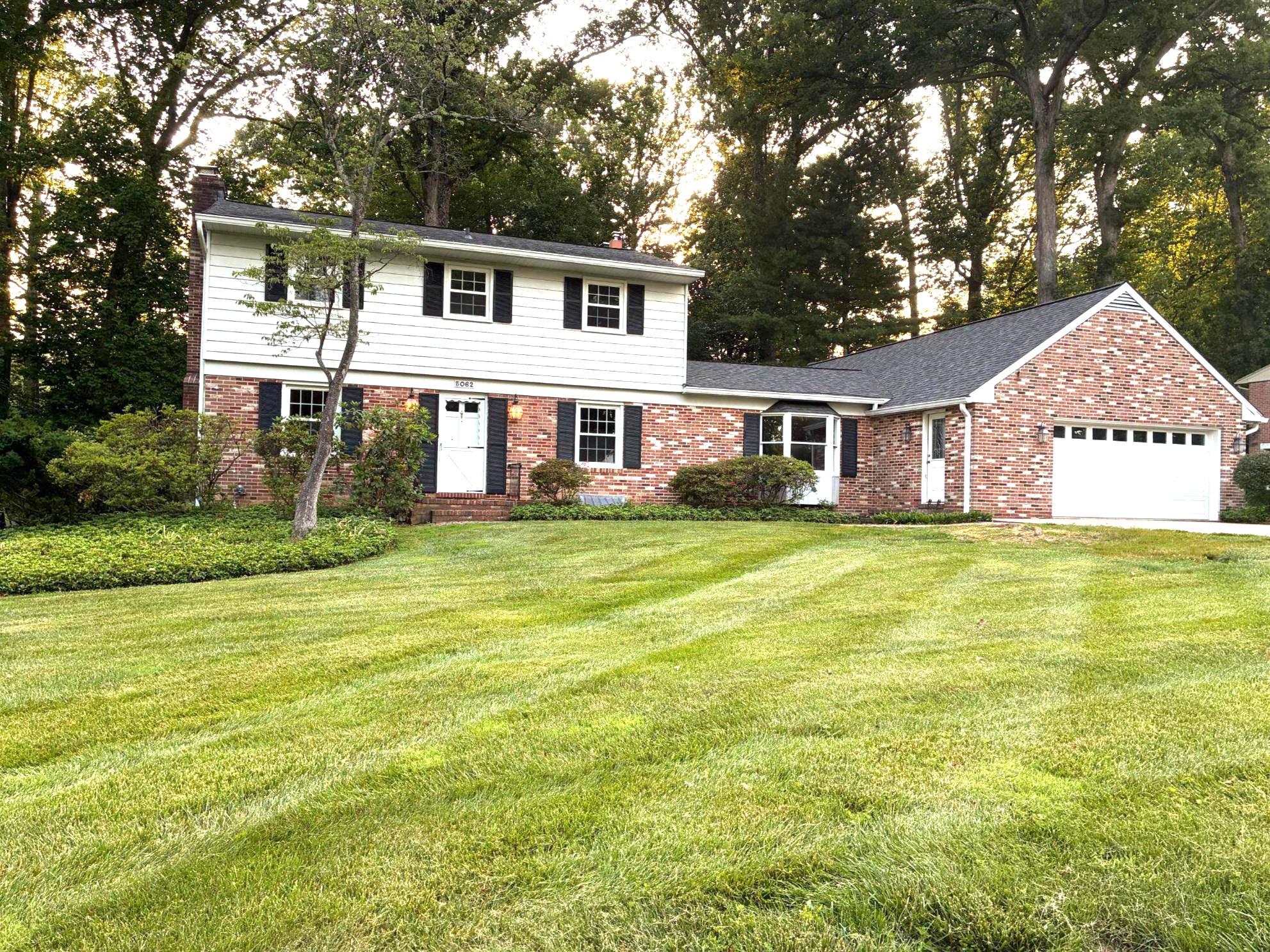 Welcome to 5062 Durham Rd W in the beautiful neighborhood of Beaverbrook!  With over 4700 square feet, this lovingly maintained home will surprise you with all the extra space.  Enter through the owner's hall to the heart of the home.  The expansive great room has an impressive wall of built-in shelving, storage cabinets, a vaulted ceiling, custom wood accent wall, exposed beams, skylights, a beautiful stone fireplace with cozy gas insert, and oversized doors to the deck.  
One of the special features of this home is a large main level accessible bedroom with a newer slider to the deck, ideal for an in-law or au-pair suite.  There are 2 spacious closets - a walk-in closet, and a generous cedar closet.  The attached full bath offers a roll-in shower.  This is one level living at its finest.  
The eat-in kitchen has a brand new 5 burner gas stove, part of the Samsung SmartThings series.  Plenty cabinetry is available, along with a walk-in pantry, and window overlooking the backyard. 
Pop out the slider to enjoy cookouts with friends on the expansive deck with an accessible ramp.   Greet guests through the front entrance, and relax in the formal dining and living rooms.  A brick fireplace and natural hardwood floors enhance the main level.  There is another bedroom with an en-suite full bath and new vanity featured on the upper level, plus 3 additional bedrooms with ample closet space. The 3rd full bath has a shower/tub available to the remaining bedrooms.    
The lower level provides a wonderfully large family room with high ceilings and a fireplace, a bonus/study/guest room, a separate storage room, a workshop area with extra storage space, laundry, and steps to the back yard. 
There is an additional potting shed/workshop area in the oversized 2 car garage and a huge driveway, all on a beautiful half acre, partially wooded yard.  Some new updates include freshly painted neutral colors, a remodeled family room, new bay window in the great room, new 5 burner gas stove, and some lighting (2026), a new architectural shingle roof (2025), slider & HVAC (2023). This special outparcel neighborhood of Columbia welcomes you with large lots, wide roads and its own lovely community lake, plus there are no mandatory CA fees, no HOA fees or no FFA fees!  Cross Rt 108 to the amenity rich Centennial Park with sports fields, miles of paths, and paddle boats on the lake for summer fun. Easy access to Rts 29, 100, 32, & shopping or Rt 40 in Ellicott City.  Not far from BWI, MARC Train, NSA, and Ft Meade, and centrally located between Baltimore & Washington DC.  Call your agent today to schedule your private tour!