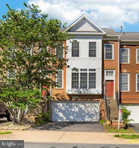 Welcome home to this beautiful, sun-drenched 3-level brick front townhome in the peaceful and beautiful neighborhood of Forest Park! Featuring over 2,300 square feet of freshly painted finished living space, this home excels with a spacious 2-car garage. Open-concept main level features an oversized living room anchored by large windows that flood the home with natural light. The newly renovated open kitchen includes brand new quartz countertops, sink and faucet,  table space, and a cozy bar area that leads directly to the backyard—perfect for seamless indoor/outdoor entertaining. Upstairs, you’ll find a convenient bedroom-level laundry room and 3 spacious bedrooms, including a primary suite complete with double sinks, a soaking tub, and a separate shower. The finished lower level features a cozy fireplace, making it the ultimate space for a rec room, media room, or home office. Additional bathroom roughed-in on the lower level, to make it very easy to add another bathroom. Plenty of guest and street parking available. Ideally located just minutes from I-95, Route 1, the express lanes, shopping, and commuter options. Community amenities include a pool, playgrounds, and common grounds. Move-in ready and waiting for you!