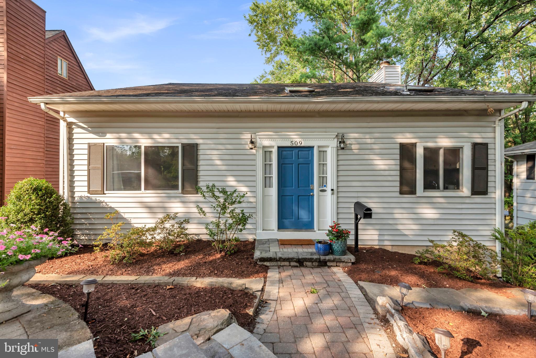 Located in the sought-after, water-privileged community of Admiral Heights, this beautifully maintained 4-bedroom, 3-bath home offers a rare main-level primary suite, spacious light-filled living areas, and a large, private backyard surrounded by mature trees. Hardwood flooring extends throughout the main and upper levels, while the inviting living room features a wood-burning fireplace. The finished walkout lower level with a bedroom, full bath, and patio access provides flexible space for guests, recreation, a home office, or a gym, with abundant storage throughout.

Outside, enjoy professional stonework in the front yard, a paver driveway, and a large maintenance-free deck overlooking the private backyard—perfect for entertaining or relaxing. Leave the car behind and enjoy an exceptional walkable lifestyle, just minutes to West Annapolis shops and restaurants, Navy-Marine Corps Memorial Stadium, parks, and the community dock/pier, pool, and kayak launch. Downtown Annapolis is just over a mile away, with easy access to Route 50 for commuting. Residents may also join the voluntary Admiral Heights Improvement Association, providing access to neighborhood amenities including the pool, community dock/pier, parks, and kayak/canoe storage.