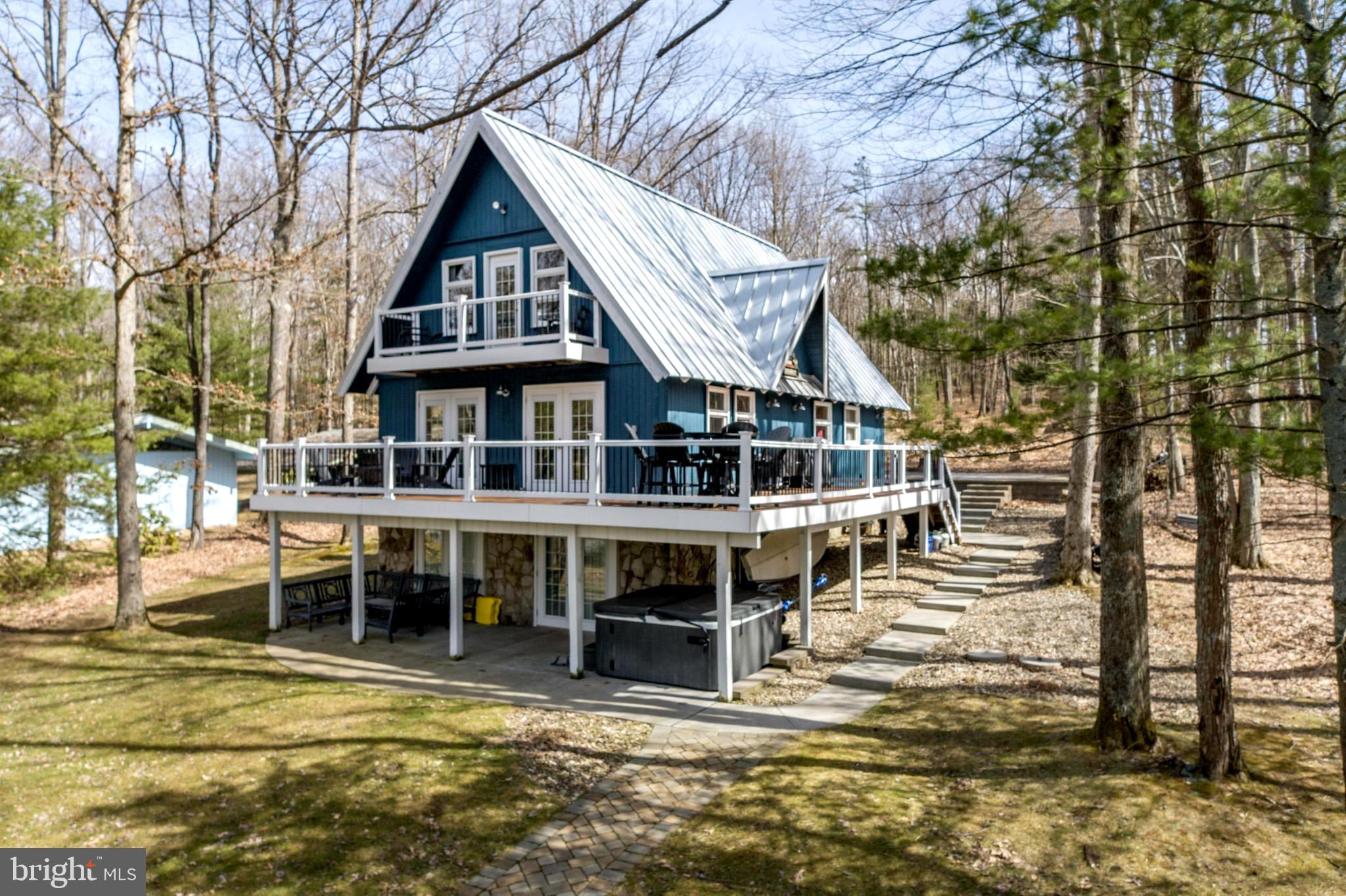 Lakefront chalet home in a peaceful cove with sunset views!  This 5 bedroom 3 bath, 2 fireplace lakefront retreat has been updated and offers plenty of indoor and outdoor living spaces.   Located on the non commercial southern end of the lake and within a few hundred yards of the incredible Thousand Acres Golf Course, now  with 18 holes.  Perfect for all water activities including sailing and kayaking.   Includes dock, storage buildings etc.

DISCLOSURE:  RAILEY REALTY IS NOT THE CARETAKER OF PROPERTIES LISTED BY IT.   DURING INCLEMENT WEATHER CONDITIONS, PROSPECTIVE PURCHASERS AND THEIR AGENTS ASSUME ALL LIABILITY ASSOCIATED WITH OR BY WEATHER AT THE PROPERTY.