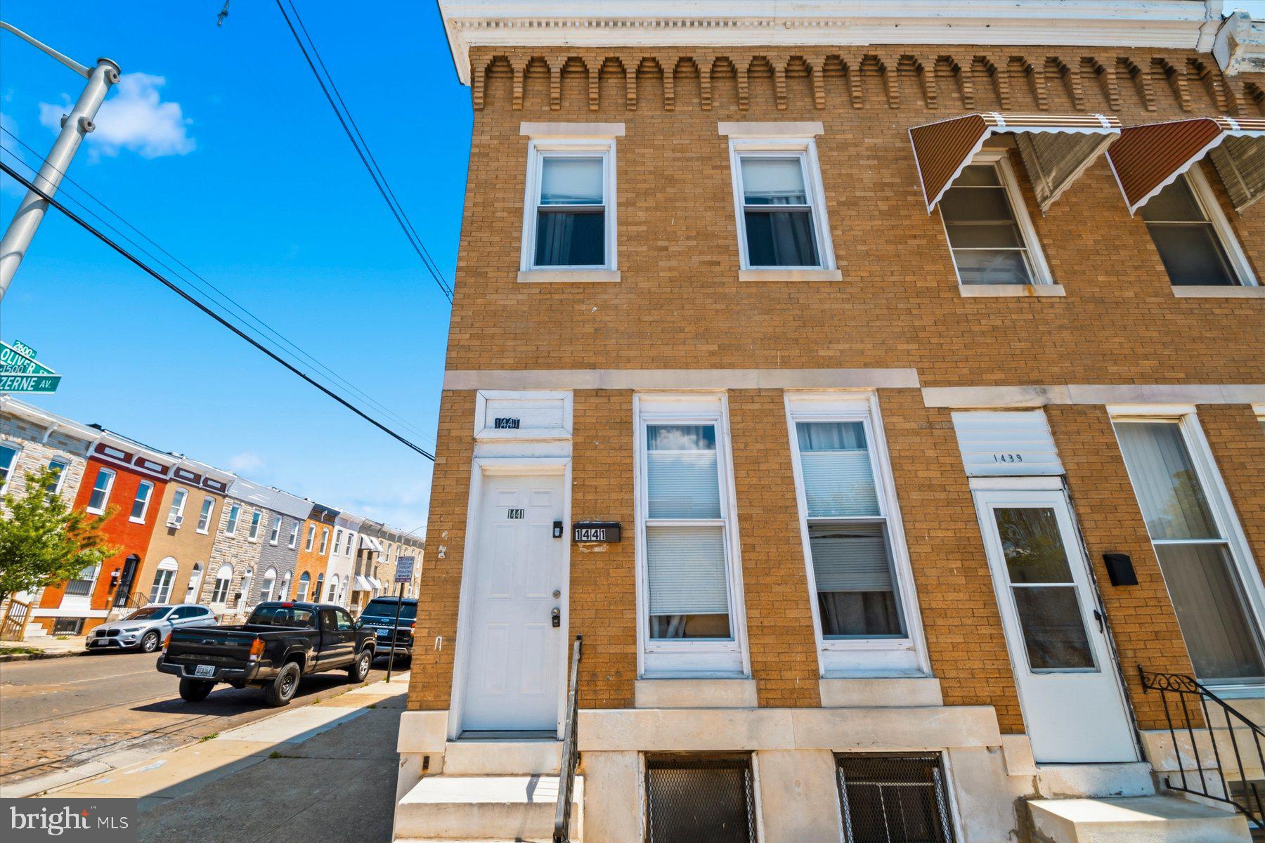 Classic Baltimore end-unit townhouse featuring four bedrooms, two full bathrooms, and a convenient half bathroom in the basement. Large living room windows fill the home with abundant natural light, creating a bright and welcoming atmosphere. The property also includes a spacious unfinished basement with excellent storage or future finishing potential.