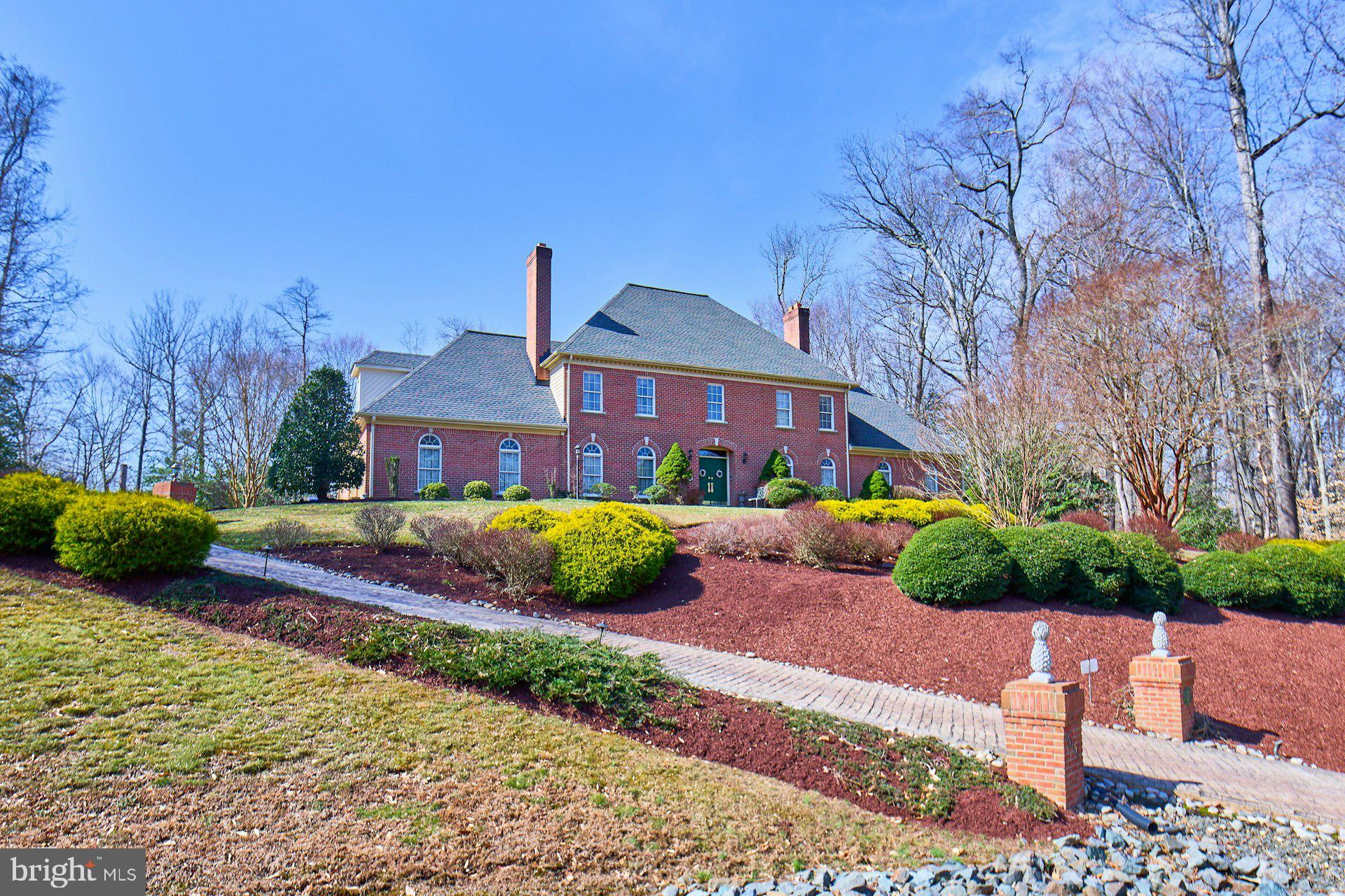Welcome to your private sanctuary at 6051 Adams Drive, nestled in the sought-after Caernarvon Woods subdivision of La Plata MD. This stately residence, lovingly maintained by its second owner, spans an impressive 6,753 total square feet across 2.64 acres and offers 4 spacious bedrooms and 2 full plus 2 half bathrooms. As you approach, you'll appreciate the heated driveway and the convenience of an in-ground sprinkler system, ensuring lush landscaping year-round.

Step inside to a grand foyer with an elegant stairway that sets the tone for this remarkable home. The sunken living room, featuring hardwood floors, a wet bar, and a vaulted ceiling, invites relaxation and entertainment. The kitchen is a chef's delight, complete with a center island cooktop, ample table space and abundant cabinet storage. This home offers flexible living arrangements, perfect for guests or an in law or au pair suite. There is a second kitchen which has direct access to the expansive deck and an upper level bedroom. 
Upstairs, the primary suite offers a luxurious retreat with his and hers closets, ensuite bath with a soaking tub, shower and dual vanities.

The unfinished basement offers tremendous potential for additional value. Whether you envision a state-of-the-art home theater, a personal gym, a recreational game room, or additional living quarters, the potential for customization is limitless.

Outside, immerse yourself in the beautiful surroundings—a fenced yard and wooded landscape. To enhance your outdoor experience, enjoy the fire pit, patio and a Koi pond, water feature and fountain plus the outdoor speakers connect to a stereo in the 3-car garage for your listening pleasure. This home is not just a place to live; it's a lifestyle, blending nature, comfort, and endless possibilities.