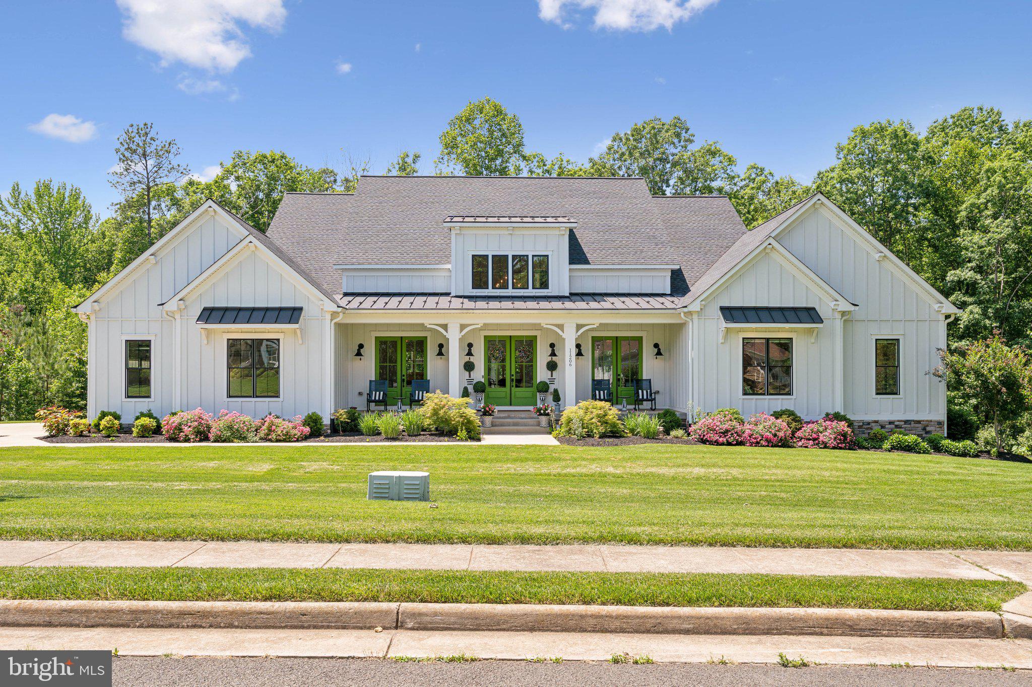 Extraordinary Modern Farmhouse on Double Lot with Designer Finishes & Resort-Style Amenities
Welcome to this one-of-a-kind modern farmhouse, situated on two legally joined lots in an exceptional community offering unmatched comfort, luxury, and lifestyle. The striking home features board and batten siding with stone accents, a three-car side-load garage, and a charming country front porch with three entrances. Designer farmhouse lighting, lush professional landscaping, and elegant exterior finishes set the tone for what awaits inside. Step through the front doors into a wide-open floor plan filled with high-end finishes. The gourmet kitchen is a showstopper, boasting top-of-the-line Cambria quartz countertops, massive center island, pot filler, gas cooktop, stainless steel appliances, subway tile backsplash, and soft-close cabinetry with custom spice drawer. Farm-style doors lead to a dream walk-in pantry—complete with open shelving, beverage fridge, farmhouse sink, and floor-to-ceiling cabinetry—essentially a second kitchen!
The heart of the home is the spacious dining and family room with a stunning stone gas fireplace and a 16-ft pocket sliding glass door that opens to an expansive outdoor living area. Entertain in style with a covered outdoor kitchen, built-in grill and hood, wraparound bar, fireplace, beverage fridge, Trex decking, and floor-to-ceiling screened porch—all designed for year-round enjoyment.
To the left of the kitchen, the laundry/mudroom impresses with designer tile flooring, custom cabinetry, utility sink, and open shelving. The primary suite is a true retreat, showcasing vaulted ceilings, a statement chandelier, private porch access, and sliding barn doors opening into a luxurious spa bath. Enjoy a floor-to-ceiling tiled shower bathroom with multi head shower and bathtub built in behind a floor to ceiling glass wall. There are dual vanities with touch-activated LED mirrors, and a massive walk-in closet with adjustable Container Store system. Additional highlights on the main level include:
Private home office with custom built-ins and barn doors, Secondary primary suite with oversized bathroom,
elevator access between the main and lower levels, two more spacious bedrooms with Jack & Jill bath
Upper Level, upstairs offers two large bedrooms with a shared bath, including a bunk room with potential for future expansion,lower Level: The finished walkout basement includes two additional bedrooms with a Jack & Jill bath, large rec room, home gym, and an unfinished space, capable of building out to full multi-generational living including full kitchen bringing the house to more than 8000 sq ft.    Step outside to your private oasis—a concrete patio leads to a gorgeous heated pool with lighting, fountain features, and an electronic safety cover. A pool house provides ample storage for equipment. 
Smart Home & Utility Features, Whole-house generator, Tankless water heater, Electronic air filter & allergy scrubber, EV charger in garage, Programmable thermostats, Multiple Wi-Fi access points, In-ground sprinkler system, Custom lighting system for exterior eaves.  Nearly $60,000 dollars in landscaping and lawn services, and water pressure boost pumps for both inside and outside sprinkler system!
 The lower level is finished finished with two bedrooms, and capable of build out to full multi-generational living including full kitchen bringing the house to more than 8000 sq ft.    
Resort-Style Community Amenities Include: Lake with marina, Golf course, Clubhouse, Fitness center, Tennis & pickleball courts, Pools, Soccer/baseball fields, Beach area & kayak park, Sports park & walking trails, Dog park & community garden!

This home is truly one of a kind—built with thoughtfulness, functionality, and elegance at every turn. Schedule your private showing today and fall in love with everything this property and community have to offer.
