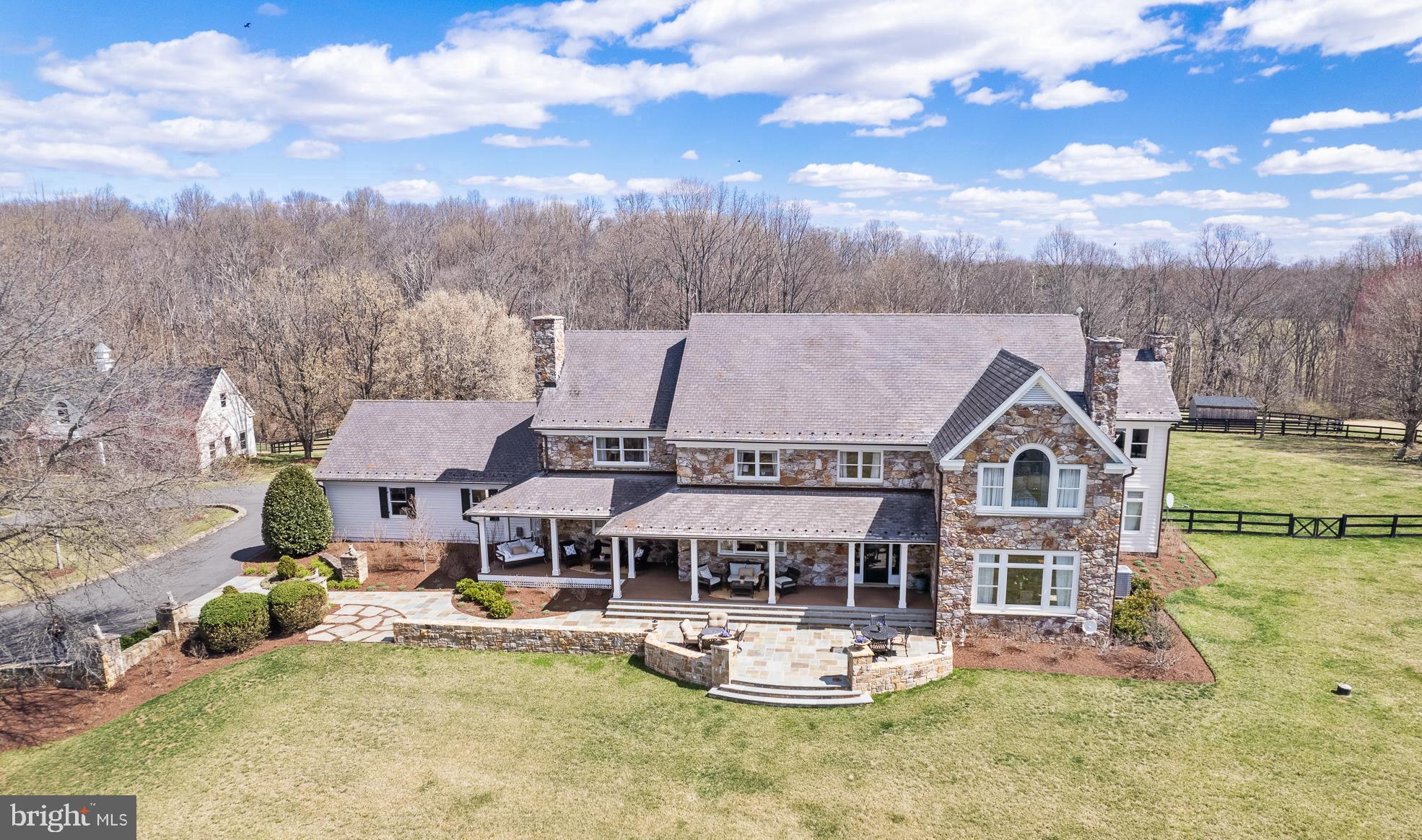 Welcome to Foxwood Hill, a breathtaking private estate just minutes from the charming village of Philomont. Designed and built by a well-respected local builder as his personal residence, this exceptional property offers over 7000 square feet of living space, a picturesque pool, a spacious workshop, and 31 acres of rolling pasture—ideal for horse enthusiasts or those seeking a tranquil country retreat.

This 5-bedroom, 4.2-bath home includes exquisite architectural details, including a gorgeous grand entryway showcasing a beautiful double staircase with two-story foyer, formal living and dining rooms, a warm and inviting family room with wood-burning fireplace, and a pantry/mudroom to die for. The thoughtfully designed layout creates an effortless flow, perfect for entertaining and everyday living.
The enormous basement provides 3 spacious finished areas, a rec room, fitness room, and yoga room, plus ample unfinished storage and half bath. A separate hidden lower level storage space is perfect for valuables/gun storage. The large workshop, originally designed for boat construction, offers endless possibilities—it could easily be converted into a barn or a guest cottage and already has rough-ins for a second-floor apartment.
For the equestrian enthusiast, the property is thoughtfully designed with three-board fencing, three well-maintained paddocks with water access, and a run-in shed for the comfort and care of horses.



The home has been extensively updated by the current owner and meticulously maintained. The kitchen was beautifully renovated with professionally refinished cabinets, new quartzite countertops, farmhouse sink, and updated stainless steel appliances. All floors and banisters have been refinished, and the entire interior and exterior have been freshly painted. New Trex front and back porches and a beautiful slate Sunset Terrace enhance the outdoor living spaces, offering breathtaking views. The entire 1/4 mile driveway has been paved and extensive new hardscaping and landscaping add to the property’s curb appeal. 



Ideally situated between Middleburg and Purcellville, this extraordinary estate offers the perfect blend of private country living with modern conveniences just minutes away. Experience exquisite entertaining at sunset, a peaceful setting, and the hunt country lifestyle you’ve been looking for at Foxwood Hill.