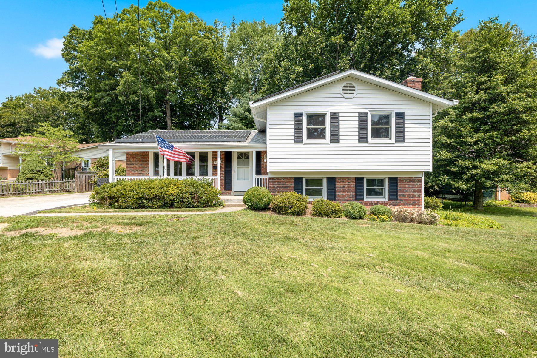 This beautifully updated, move-in-ready four-level split home is situated on a prime, professionally landscaped corner lot with an oversized driveway accommodating up to six vehicles. Its exceptional curb appeal captivates with a welcoming covered front porch, new black shutters, and energy-saving solar panels. Inside, the home shines with fresh paint, new brushed nickel hardware, and refinished hardwood floors that flow seamlessly from the foyer into a bright living and dining combination highlighted by a bay window. The kitchen features durable LVP flooring, oak cabinetry and ceramic backsplash, while French doors from the dining area lead out to a spacious deck overlooking a fully fenced backyard. This outdoor retreat boasts a patio with fishpond, enclosed vegetable garden and storage shed. Upstairs, the home offers three generous bedrooms with double-door closets and refinished hardwoods, including a master bedroom with direct access to the full hall bath. The cozy lower level features a spacious family room with new carpeting, built-in shelving and fireplace with cast iron stove insert, a fourth bedroom, and a full bath with custom ceramic-surround shower. Finally, the sub-basement provides a highly functional utility, laundry, and workshop space equipped with a workbench, built-in shelving, and freshly painted floors, completing a home that truly offers total peace of mind and pride of ownership.