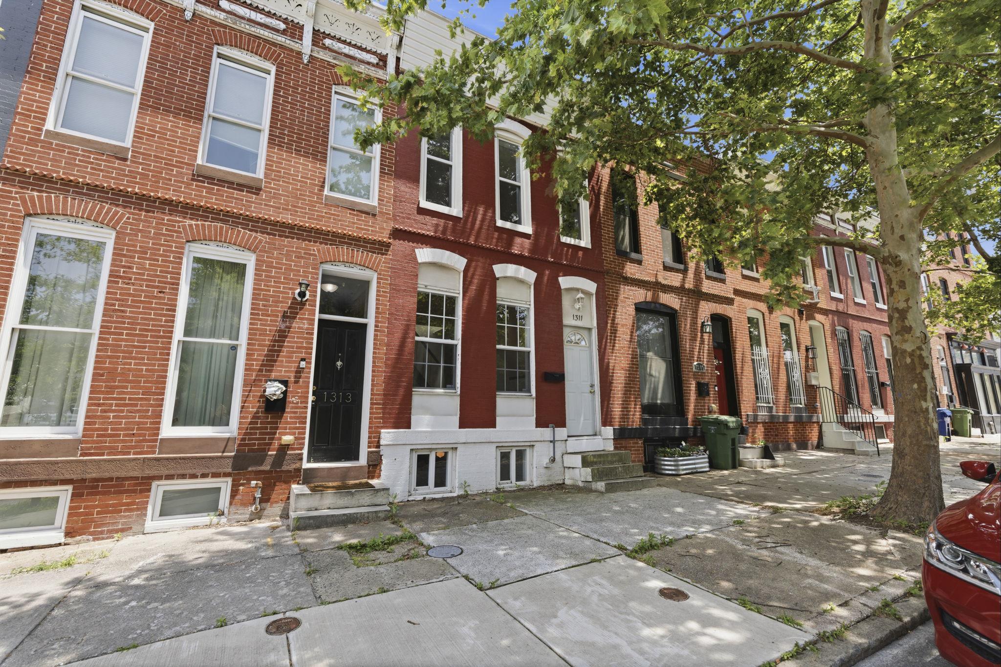 Welcome home to Broadway East! Conveniently located in a neighborhood that has undergone incredible transformation, 1311 N. Broadway provides the perfect opportunity to own a piece of the action without paying top dollar. This property may also qualify for valuable grant programs like “Buy Back the Block” (inquire with listing agent for more info). One of the first things you’ll notice when walking through the front door is the ample daylight, thanks in part to the skylight at the top of the staircase. The first floor features a living area centered by a brick hearth. The eat-in kitchen is spacious and versatile, and just off of this area you’ll find a half-bath. A deck with stairs to the rear fenced-in yard awaits you just outside the back door. Upstairs, the large front bedroom is adorned by three large windows and has ample space and a walk-in closet. Down the hall, the second bedroom features another skylight. At the end of the hall, you’ll find a large full bathroom with laundry hookups (no hauling baskets to the basement!). One more unique feature is the second story balcony at the end of the hallway, overlooking nearby neighborhoods and an open area behind the house. In the basement, you have yet another room to use to your liking - perfect for a den, office, workout room, or even a 3rd bedroom. Despite being in the lower level, two windows still allow natural light in this room as well. *NEWLY COATED ROOF* For added peace of mind, the roof has been freshly coated. Broadway itself has a park-like median with tall trees and a large grassy area, perfect for strolls or dog-walking. What better way to own a piece of the ongoing renaissance in east Baltimore? Please note that photos of some rooms were digitally staged to demonstrate how they could look if furnished.