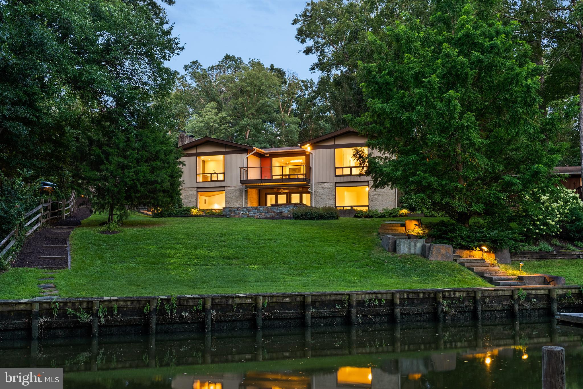 Welcome to 3010 Cunningham Drive - an exceptional mid-century modern home offering 88 feet of serene waterfront on navigable Little Hunting Creek. Rarely available with water views of Little Hunting Creek from nearly every room and a seamless connection to nature, this River House model is designed for both effortless living and elegant entertaining. Step inside to find an open main-level floor plan with striking wood-accent ceiling in the recreation rooms, recessed lighting throughout, large windows flooding the room with natural light, and a gourmet eat-in kitchen featuring stainless steel appliances and granite countertops. Host with ease in the formal dining room that opens to a spacious Trex deck—ideal for alfresco dining and enjoying tranquil views. With 2,970 finished square feet, 5 bedrooms and 3 full bathrooms, the home offers space for both privacy and togetherness. The primary bedroom retreat is a sanctuary of its own, complete with an ensuite bath, walk-in closet, and picture-perfect views to greet you each morning. Outside, the beautifully landscaped grounds and extensive hardscaping create a peaceful oasis. Relax on the slate patio (with hot tub!) or follow the private walkway to your floating dock—perfect for launching a kayak or simply enjoying the water. A 2-car garage and driveway provide ample parking, and the location offers the best of Alexandria living with the peace of a private waterfront escape. Whether you're looking to unwind or entertain, this Wessynton waterfront home delivers a lifestyle of comfort, beauty, and connection to nature. Property comprised of two lots (1111 12 0051 & 1111 12 Q1). Taxes on the "outlot" are approximately $12.00 per year. Although shown as a "recreation" association, this water-front property's second association is the Wessynton Marine Association; annual fees are listed as "recreation," and are NOT optional. There are separate disclosure packages for the Wessynton Home Association and the Wessynton Marine Association. Key documents are posted on the neighborhood website in Association Information and in Special Features