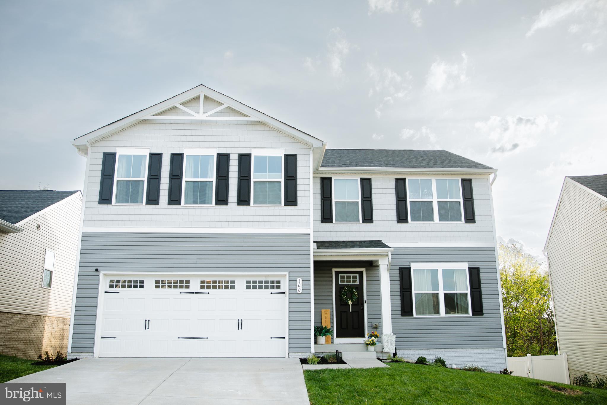 This beautiful, move-in ready home located in The Villages at Middletown offers the perks of new construction without the wait.  This home features 5 bedrooms, 2.5 bathrooms with 2,210 square feet.  The open-concept main level offers a huge kitchen with stainless steel appliances and upgraded kitchen cabinetry, the kitchen opens up to a dining area and a large family room with lots of natural light.  There is also a flex room on the main level that can be used for office or sitting area.  The trex back deck  is great for entertaining as it offer lots of additional outdoor living space.  Upstairs the primary suite includes two walk-in closets and an ensuite bathroom with double vanities.  Four additional bedrooms with walk-in closets share a full bathroom with double vanities.  The laundry room is conveniently located on this level.  The full unfinished walkout basement offers rough-in plumbing for future expansion.