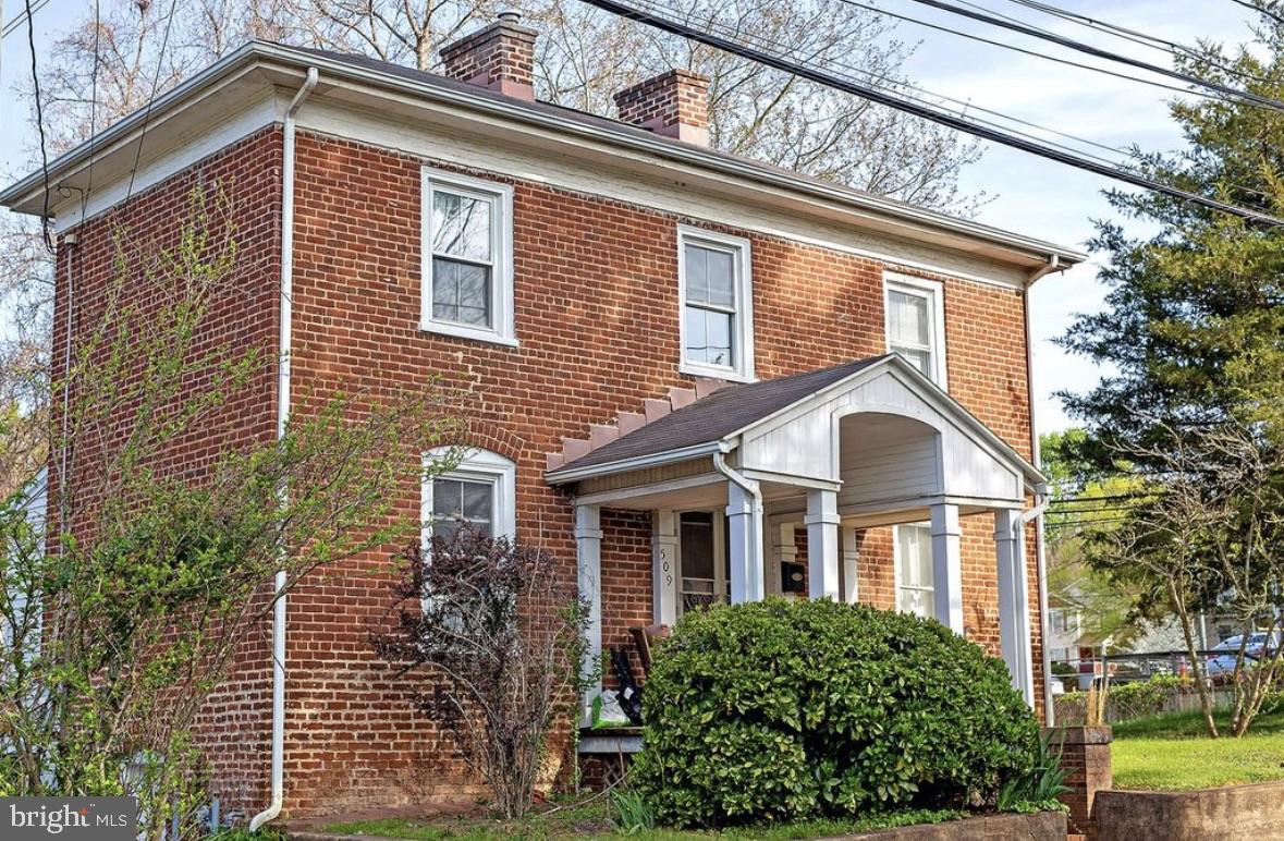 Classic Brick Colonial in Charlottesville's Fifeville Neighborhood - Value-Add Opportunity Set on a generous, tree-lined lot just south of Downtown Charlottesville and minutes from UVA and the UVA Medical Center, 509 71⁄2 St SW is a 1920s brick colonial with the kind of bones that are increasingly hard to find this close to the city center. A classic front porch with white columns and
brick steps welcomes you in, while inside, original hardwood floors and a traditional layout offer a strong foundation for renovation or rental use. Highlights: 3 bedrooms, 2 bathrooms across approximately 1,318 sq ft Solid brick construction with a traditional center-hall colonial layout Original hardwood floors throughout much of the main level Covered front porch with classic
colonial columns Rear wood deck overlooking a large, mostly-cleared backyard Generous 4,399 sq ft lot with mature trees and room to landscape Located in the walkable Fifeville neighborhood - close to UVA, the Corner, Downtown Mall