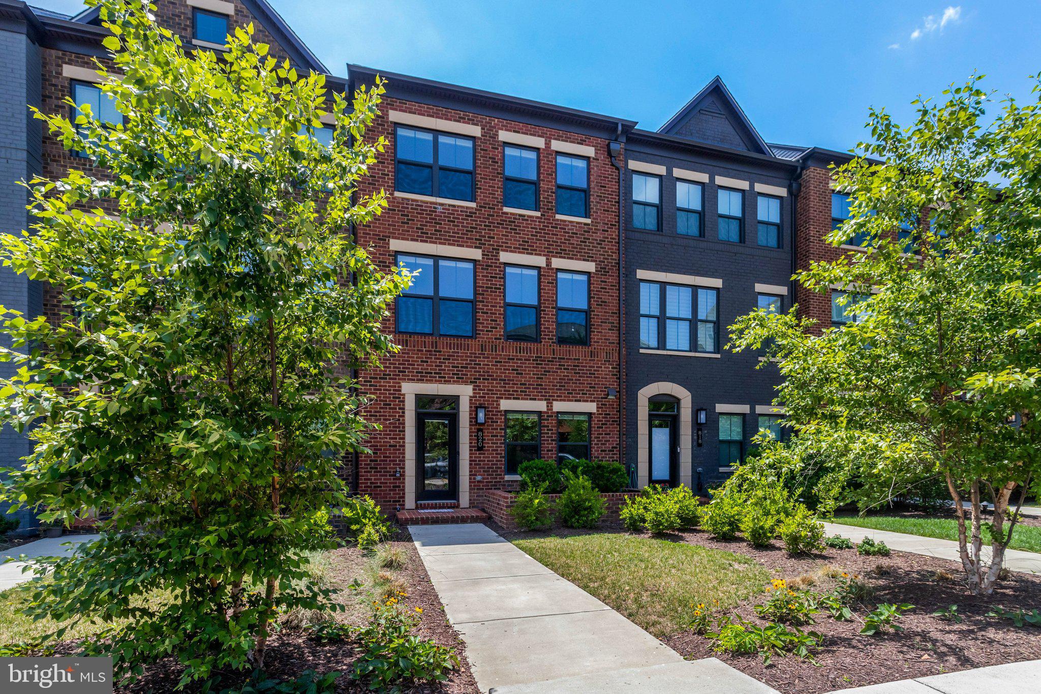 Experience sophisticated townhome living in this beautifully appointed Hancock Grand by NV Homes, offering four finished levels, premium upgrades, and an exceptional location in Arlington’s sought-after Carlin Place community.

A welcoming foyer leads to the first-floor bedroom with a private full bath, creating the perfect space for overnight guests, multigenerational living, or a quiet home office. This level also provides direct access to the oversized finished two-car garage and the utility room, featuring a Carrier high-efficiency gas furnace with a humidifier, an Aprilaire Healthy Air filtration system, a Noritz tankless water heater, and the home’s sprinkler system control.

Designed for both everyday living and effortless entertaining, the main level offers a seamless flow between the spacious living room, dining area, and chef-inspired kitchen. The kitchen is beautifully appointed with GE stainless steel appliances, a generous quartz center island, Calacatta Lava quartz countertops, a farmhouse sink, subway tile backsplash, under-cabinet lighting, matte black fixtures, soft-close cabinetry, a convenient pot filler, and a built-in wet bar. Thoughtfully designed custom closets maximize storage throughout the pantry, main-level coat closet, and the expansive primary walk-in closet.

Just beyond the main living area, the impressive, enclosed lanai extends the home’s living space and serves as a true year-round retreat. Featuring a dramatic floor-to-ceiling stone accent wall and a cozy gas fireplace, this inviting space is perfect for relaxing or entertaining in every season.

The third level is dedicated to the luxurious primary suite, complete with a spacious walk-in closet and a spa-inspired bath featuring dual vanities, an oversized shower, and a private water closet. A second generously sized bedroom offers its own ensuite bath, while a conveniently located laundry area adds everyday practicality.

The fourth level features an additional private bedroom suite with a full bath, along with access to the rooftop balcony—an ideal setting for outdoor dining, entertaining guests, or simply relaxing while enjoying the surrounding views.

Ideally situated just minutes from Glencarlyn Park, neighborhood trails, dog parks, restaurants, shopping, and public transportation, this exceptional home also offers easy access to Routes 7 and 50, I-66, I-395, and downtown Washington, D.C.

Luxury, comfort, and convenience come together in one exceptional residence.

Bonus for Buyers! Seller is offering a $10,000 credit at settlement that can be used toward hardwood flooring, a custom closet organization system, closing costs, or however the purchaser chooses. A wonderful opportunity to personalize this exceptional home while enjoying added savings.