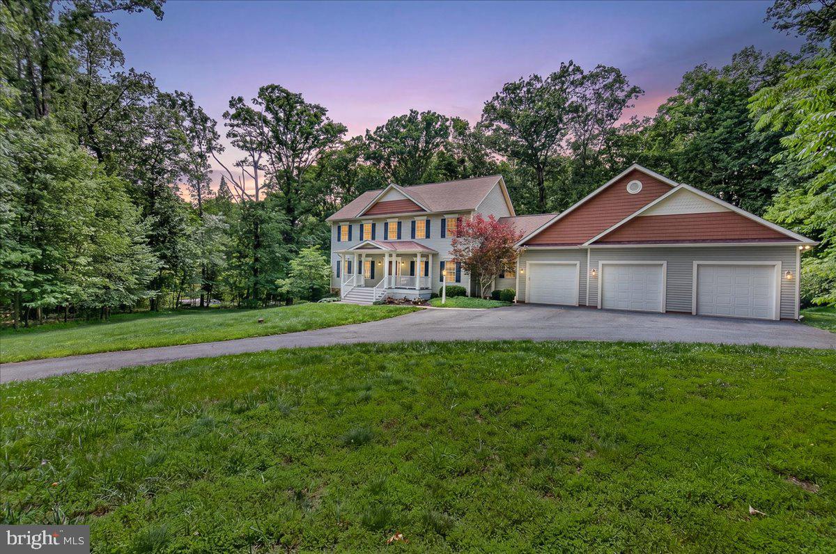 Nestled within the prestigious Daisy Hill Estates, this exquisite custom built colonial embodies the pinnacle of fine living. Surrounded by extrodinary equestrian country, this Howard county estate spans an impressive 4,880 square feet utilizing every square inch to perfection. With access to the country's top rated schools, academics and distanced perfectly to all amenities, 2516 Daisy Rd is meticulously crafted, offering a harmonious blend of elegance and modern convenience, set against a backdrop of lush landscaping and serene wooded views on a sprawling 2.99-acre lot. Step inside to this well thought out floor plan to discover a grand foyer adorned with crown moldings and rich hardwood flooring that flows seamlessly throughout the main level.  You will also find a main level bedroom suite with its own ensuite (as every bedroom in the home has)  The heart of the home is the gourmet kitchen, a culinary enthusiast's dream, featuring soaring cathedral ceilings, stone countertops, a spacious breakfast area, and a suite of high-end appliances, including a double wall oven and a down-draft cooktop. Right off the kitchen is the large walk in pantry room. The formal dining area, accentuated by chair railings, sets the stage for elegant dinner parties, while the expansive living spaces are bathed in natural light from double-pane insulated windows. The thoughtful floor plan includes five generously sized bedrooms, each designed with comfort in mind, and five luxurious full bathrooms, ensuring ample space for relaxation and privacy. Retreat to the primary suite, a sanctuary of tranquility featuring a spa-like en-suite bath, complete with dual vanities and exquisite finishes. Additional highlights include a fully finished basement with a walkout entrance bedroom suite and ensuite, providing versatile space for recreation or relaxation or perfect in-law or nanny suite. A dedicated laundry area conveniently located on the upper floor- although there are laundry hookups on every level to include the large mudroom and the lover level. The exterior of the property is equally impressive, showcasing extensive hardscaping that enhances the outdoor living experience. Enjoy al fresco dining on the expansive deck or unwind on the charming porch, all while surrounded by Howard county's serene countryside that offers both beauty and privacy, yet moments from major travel arteries. The property also features a three-car attached garage with a front entry, TESLA car hook up and ample storage. This home is equipped with modern security features, including a comprehensive security system and smoke detectors, providing peace of mind. With no pool to maintain, you can focus on enjoying the serene surroundings and the exclusive lifestyle that Daisy Hill Estates offers. Experience the perfect blend of luxury, comfort, sophistication and a robust community in this remarkable residence, where every detail has been thoughtfully curated to elevate your lifestyle.

* Look for the specification list in which the construction materials and features are listed *