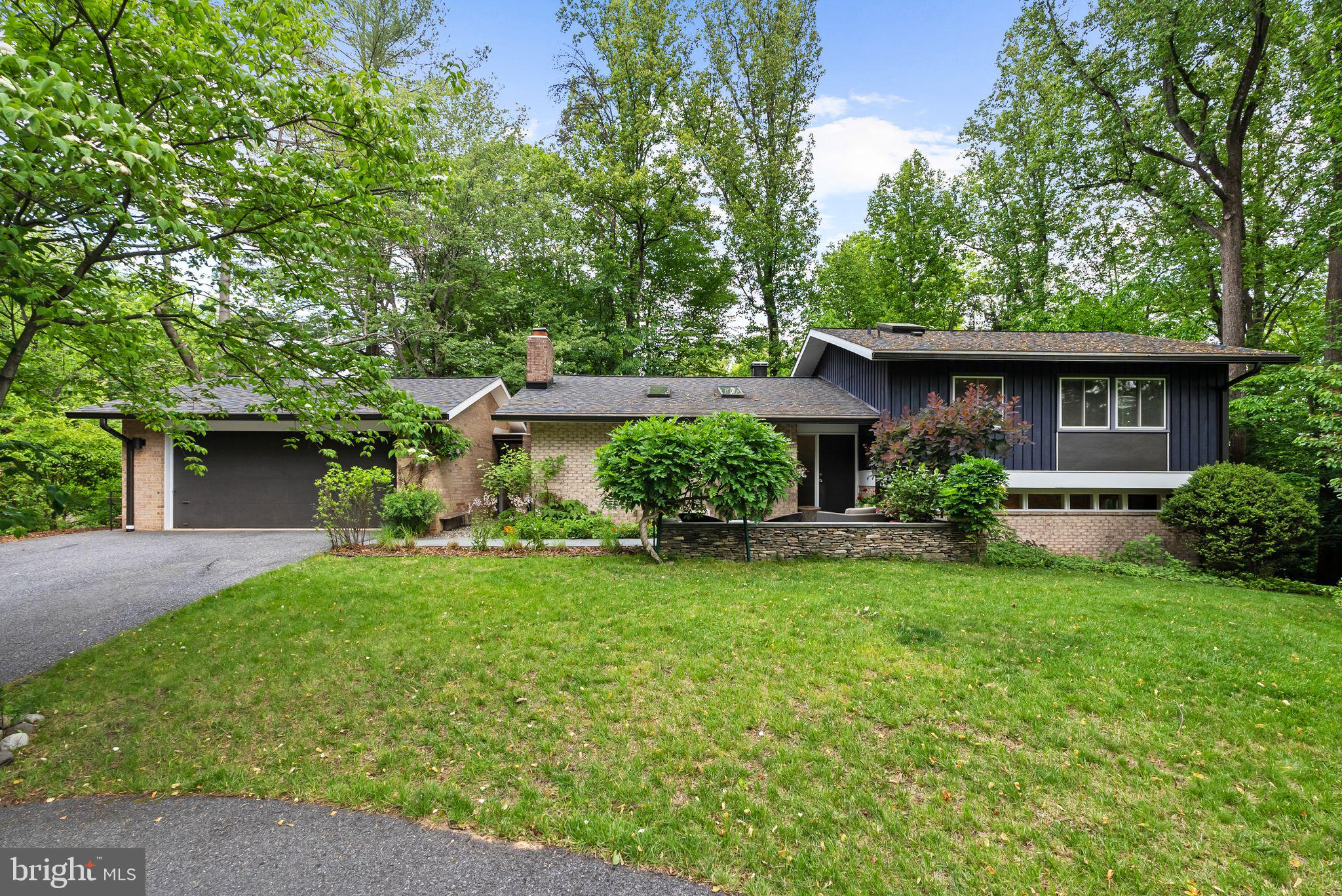 Open House 5/23 is canceled.  Welcome to 8034 Park Overlook Drive, ideally located on one of the most desirable streets in the sought after Carderock Springs community. Tucked away on a peaceful cul-de-sac and perched on a beautifully wooded 17,000+ square foot lot, this expanded Clubview mid-century modern home combines timeless architecture, flexible living spaces, and the natural beauty that makes Carderock so special. With 4 bedrooms, 4 baths, two bonus rooms, and a rare two-car garage, this home lives comfortably like a 5-bedroom home.

Step into the foyer where original wood paneling sets the mid-century tone. The main living spaces welcome you with soaring pitched ceilings, skylights, hardwood floors, and a wood-burning fireplace. The open living and dining areas flow seamlessly into the impressive sunroom — a true highlight of the home — featuring exposed wood beams, skylights, stone flooring, and walls of windows overlooking the lush greenery beyond.

The sleek updated kitchen, also complete with stone flooring, connects beautifully to both the dining room and sunroom, creating an ideal flow for everyday living and entertaining. Sliding glass doors from the sunroom open to the stunning elevated deck, built in 2020, where integrated ambient lighting creates the perfect evening setting. The deck wraps around to additional outdoor seating areas overlooking the expansive side yard, winding pathways, and a cozy fire pit tucked among the trees. Much attention has been devoted to the design of the garden, which has been meticulously maintained for many years. True to Carderock’s character, the grounds offer a peaceful retreat filled with mature trees, nature, and endless potential for gardening, entertaining, or simply relaxing outdoors.

The split-level design enhances the home’s versatility. On the upper level, you’ll find three bedrooms and two baths, including a primary suite with an ensuite bath. All three upper-level bedrooms feature skylights, filling the spaces with natural light and enhancing the home’s signature mid-century character. The lower level features a spacious family room with sliding glass doors leading out to the flat grassy yard, along with an additional bedroom and full bath. The second lower level further expands the home’s flexibility with two bonus rooms — ideal for a guest space and a home office— as well as an additional recreation/family room and laundry area.

Living in Carderock Springs offers a unique lifestyle centered around nature, recreation, and community. This property includes membership to the Carderock Springs Swim and Tennis Club, featuring swimming, tennis, pickleball, summer camps, swim and dive teams, the Carderock market, and other amazing community events. Nearby hiking trails, the C&O Canal, and the Potomac River provide endless outdoor recreation, while Potomac Village and dining along MacArthur Boulevard are just minutes away.

The home is served by Carderock Springs Elementary, Pyle Middle School, and Walt Whitman High School. Moreover, the neighborhood's inclusion in the National Historic Registry underscores its timeless appeal while covenants, an architectural board, and a tree committee contribute to the preservation of its unique character and natural beauty.

Additional updates include a roof replaced in 2022, HVAC system in 2019, and water heater in 2019.

With its timeless mid-century design, flexible living spaces, and peaceful wooded setting, 8034 Park Overlook Drive is a special opportunity to experience the very best of life in Carderock Springs.