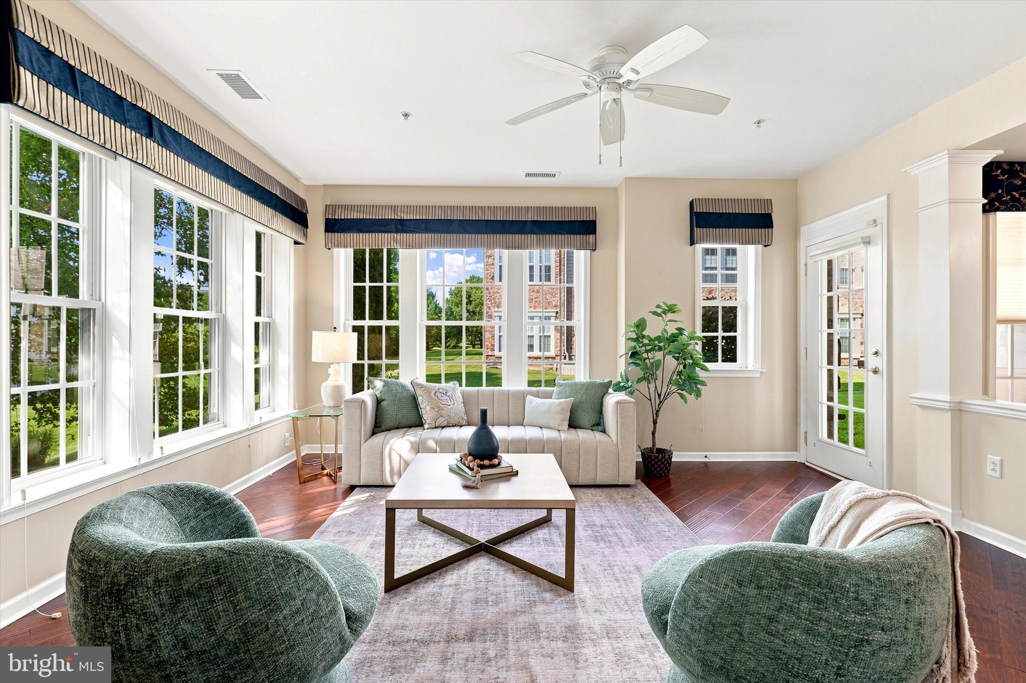 Welcome home to 6102 Lilac Court! This rarely offered Anthem model corner unit sits in the award winning 55+ community of Reserve at Gwynedd, and it truly shows like a model home. This bright, sun filled 2 Bedroom, 2 Bath residence offers over 1,700 square feet of open concept living, plus a deeded underground parking space and private storage locker.

Beautiful wood flooring, complete with a custom floor medallion, flows through the foyer, Great Room, Kitchen, and Dining Room, while crown molding and wainscoting add timeless, elegant character throughout. The eat in Kitchen with pantry has been thoughtfully designed with a ceramic tile floor, a  new refrigerator,  dishwasher and microwave, all alongside 42" cabinets and a breakfast bar that's perfect for casual mornings or easy entertaining.

The tray ceiling Dining Room and spacious, sunny Living Room open to a private patio with beautiful green lawn and landscape, creating a peaceful backdrop for gathering with family and friends. The spacious Primary Suite offers a walk in closet (professionally  designed for custom use) and a spa like Bath featuring a double sink vanity, soaking tub, private WC, walk in shower and linen closet.  A generously sized second Bedroom which can be used as a den or office, with a double closet.  A  full hall Bath, and large Laundry Room with a brand new washer and dryer completes this move in ready home.    Pet or no pet, this first floor condo offers entrance through the lobby or your own private entrance.

Beyond your front door, enjoy resort style, carefree living with two clubhouses totaling over 16,000 square feet, indoor and outdoor pools and hot tubs, a fitness center, billiards, a library, and card and craft rooms, all coordinated by a full time activities director offering clubs, classes, and trips.
Come for the condo, stay for the lifestyle. Schedule your private showing today!
