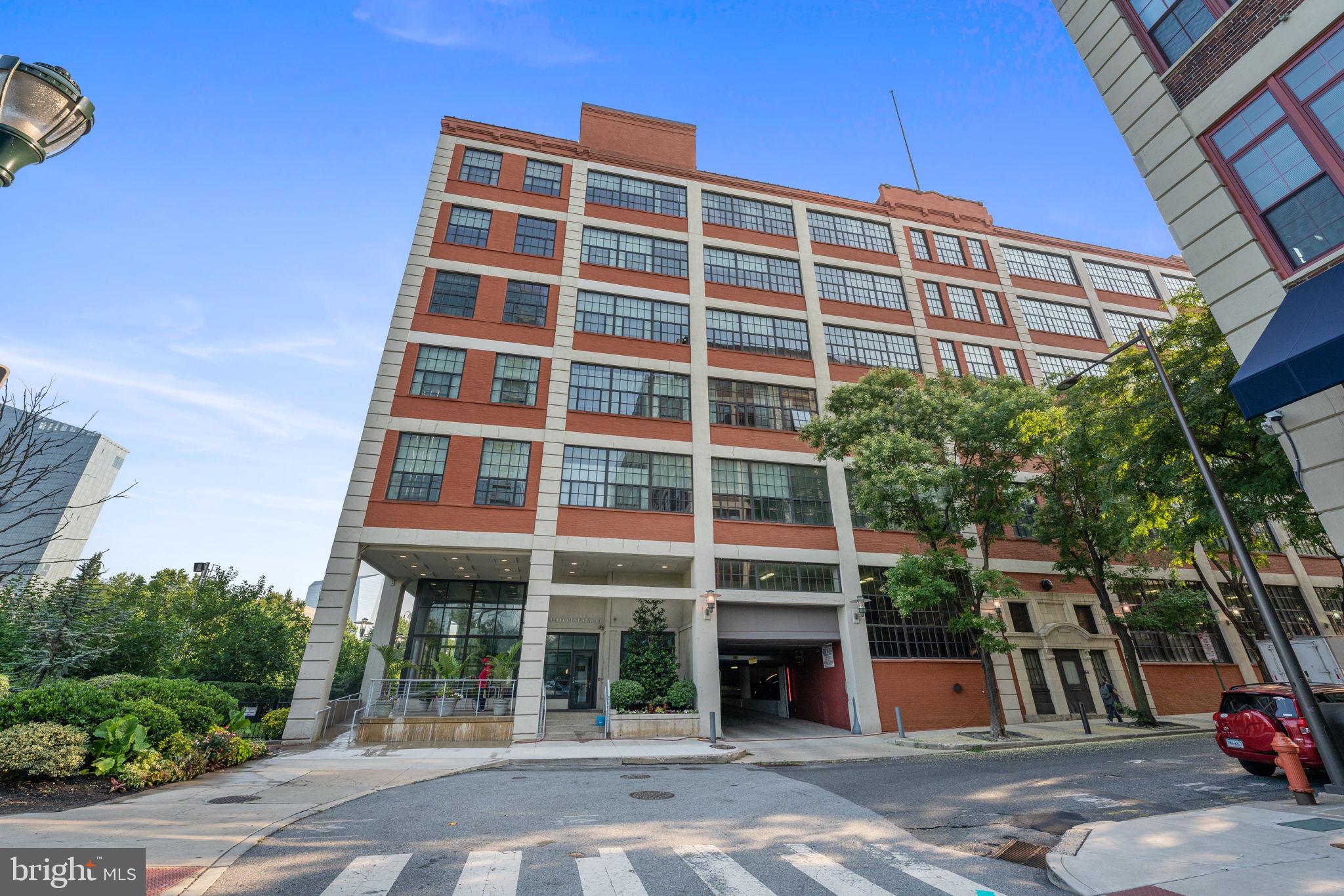 **The sellers are offering to pay for one year of parking at a local parking garage around the corner from the building to a buyer that executes an AOS prior to July 31, 2026. ** Step into elevated city living with this stunning, light-filled one-bedroom loft in the highly desirable Locust Point building. Bathed in southern exposure, this airy residence features dramatic 18-foot ceilings and oversized windows that pour natural light across an open, thoughtfully designed floor plan—perfectly balancing industrial character with modern sophistication. Rich hardwood floors flow throughout the main living space, leading to a sleek, contemporary kitchen outfitted with granite countertops, stainless steel appliances, and ample room for both everyday living and entertaining. The lofted bedroom offers a private retreat, while the full bath and in-unit washer and dryer provide everyday convenience. Additional highlights include central air, generous closet space, and a private, secured storage unit just steps away. Residents of Locust Point enjoy a host of premium amenities, including a newly renovated lobby with inviting lounge areas, an elevator, a fully equipped fitness center, bike storage, on-site management, and a terrific outdoor patio area. Ideally located just off the Schuylkill River Trail and within walking distance to Rittenhouse Square, Fitler Square, Penn, Drexel, CHOP, and 30th Street Station, this condo offers the ultimate blend of urban convenience and outdoor lifestyle. A rare opportunity to own a true loft in one of Philadelphia’s most sought-after communities—schedule your showing today.