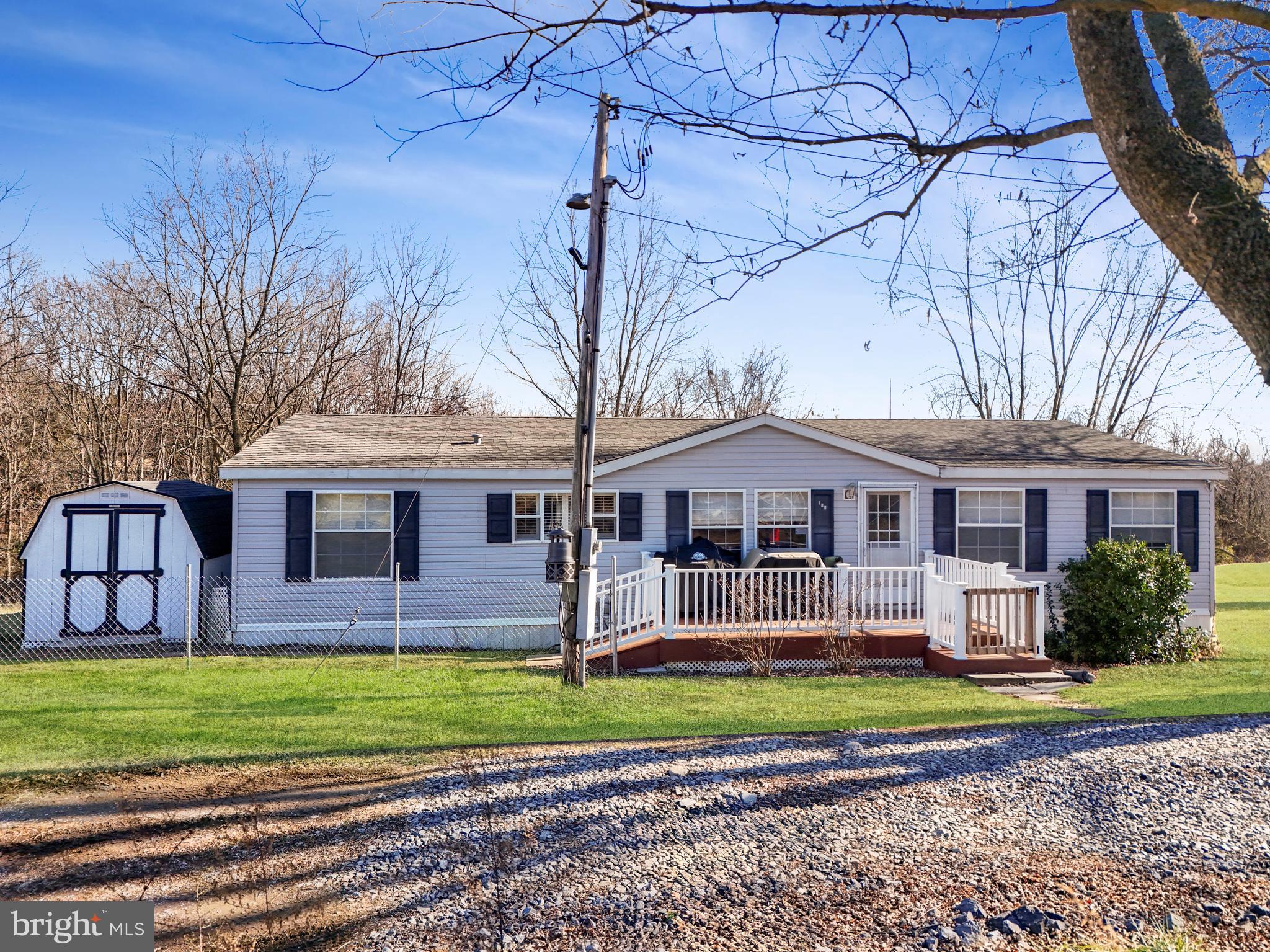 This charming ranch-style home offers the perfect blend of tranquility and convenience. Nestled on nearly 13 acres of picturesque land, this property provides ample room for outdoor activities, gardening, or simply enjoying the space. This property offers a unique opportunity with about 10.4 (+/-) unrestricted acres which may be subdividable, providing flexibility for any future plans with the property. An attached 2.5 (+/-) acre parcel is included, situated within an HOA with light restrictions, offering a balance of privacy and community.

The property includes several outbuildings, including a storage shed, carport, and a 1600-square-foot hoop barn garage with running water and its own 200-amp electrical service for all your storage or workshop needs.

Step into an open common area, including a beautifully finished kitchen and a living room complete with a wood-burning fireplace. This house offers comfortable living space with 3 bedrooms and 2 bathrooms spread across 1600 square feet. The primary bedroom includes a spacious bathroom with a spa tub and large walk-in closet for relaxation and rejuvenation.

Don't miss your chance to come see a little piece of what Wild and Wonderful West Virginia has to offer!