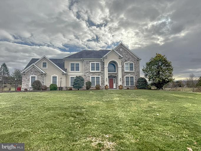 This spacious, two-story single-family home is situated on 3.5 acres in Southridge development in Fairview Township, York County, within West Shore School District. With 6 bedrooms, 4 full baths, and 1 half bath, this home offers ample space for comfortable living.
Upon entering, you'll be greeted by an open foyer leading to a well-appointed first floor. This includes a bedroom with an en-suite full bath and a private deck. The kitchen is fully equipped with granite countertops, a gas cooktop, wall oven, double stainless steel sink, and ceramic tile floors. It seamlessly flows into the eating area and living room, which boasts a cozy propane fireplace. The main floor also features an office, formal dining room with a butler's pantry, and a sunny Florida room with access to the rear deck. The laundry and mudroom offer direct access to the 3-car garage.
Upstairs, the primary bedroom is a true retreat with a spacious walk-in closet, sitting area with propane fireplace, and an en-suite master bath complete with a jetted tub, steam shower, and double vanity. Three additional bedrooms and a full bath with double vanity complete the second floor.
The finished walk-out lower level features an in-law/au pair suite with its own propane fireplace, providing both privacy and convenience. The home is equipped with modern utilities including private sewer and well, electric heat pump, and an electric water heater.
The large, level lot features a variety of fruit trees, a spacious garden area with berry bushes, and a newly installed electric fence, perfect for outdoor enjoyment and privacy.
This home is located in a peaceful, family-friendly neighborhood, offering a wonderful balance of privacy and convenience, with easy access to nearby amenities and Red Land High School.