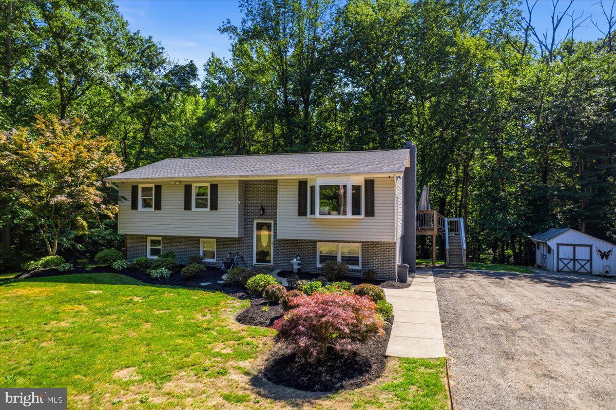 Welcome to 1610 Avery Road in Huntingtown. Nestled on 6 beautiful acres in sought-after Huntingtown, this home features 5 bedrooms and 3 full bathrooms. There is plenty of space to spread out here and so much privacy. Inside on the main level, you'll find hardwood flooring throughout the kitchen and living room. The well-appointed kitchen features an oversized refrigerator and freezer, providing exceptional storage and convenience for busy households.  Just off the kitchen is a versatile bonus room/sun room, perfect for a playroom, home office, homeschool space, hobby room, or additional sitting area. There is also 3 bedrooms and 2 full bathrooms on the main level. The lower level includes a large laundry room, recreational space perfect for a game room or theatre area plus two large additional bedrooms and a full bathroom. 
Outside, enjoy the peace and privacy of your own 6-acre property, offering plenty of room for recreation, gardening, and outdoor enjoyment. A detached garage provides additional storage, workshop space, or room for vehicles and recreational equipment.
This home has also seen several important updates, including a new well in 2021, new roof in 2022, and new water heater in 2025.
Enjoy the tranquility of country living while remaining conveniently close to local schools, shopping, dining, and commuter routes at 1610 Avery Road in Huntingtown!