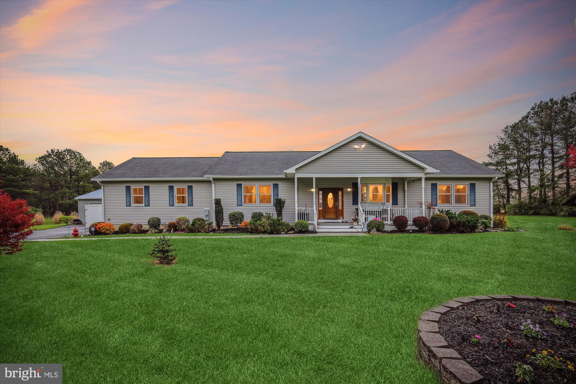Welcome to this beautifully appointed, expansive rancher offering over 2,300 sq. ft. of living space in the serene and scenic area of Church Hill, just under 30 minutes from the Chesapeake Bay Bridge.  This charming 3-bedroom, 2-full-bath home is nestled on more than 5 acres, providing both privacy and ample space to enjoy the outdoors.
Step inside and discover an open-concept, single-level floor plan with gleaming hardwood floors throughout. The gourmet kitchen is a true centerpiece, featuring stainless steel appliances including a double wall oven, cooktop, microwave, refrigerator with ice maker, and a convenient kitchen island.  An instant hot water system adds a touch of luxury.  Connected to the kitchen is a spacious living room and a stunning sunroom with vaulted ceilings and windows that offer panoramic views of the surrounding landscape.
The large primary suite is an absolute retreat, complete with a custom walk-in closet and an exquisite en-suite bath. The bath boasts a doorless walk-in shower and dual raised bowl sinks, creating a spa-like atmosphere. The two additional generously sized bedrooms share a centrally located full bath, ensuring plenty of space for family or guests.
Practicality meets luxury in the custom laundry area, which is equipped with abundant storage, counters, and cabinets. The attention to detail extends to the exterior, where beautifully landscaped grounds surround the home, with a low-maintenance front porch and rear deck off the sunroom—perfect for outdoor relaxation.
The property also includes an asphalt driveway leading to a large detached 30' x 40' pole barn with two bays, offering ample storage for vehicles or equipment.  An oversized garage, attached to the home, provides even more storage space. Whether you’re a hobbyist, a collector, or just need extra room for your vehicles, this property has you covered.
This Eastern Shore gem combines comfort, convenience, and country living at it's best!