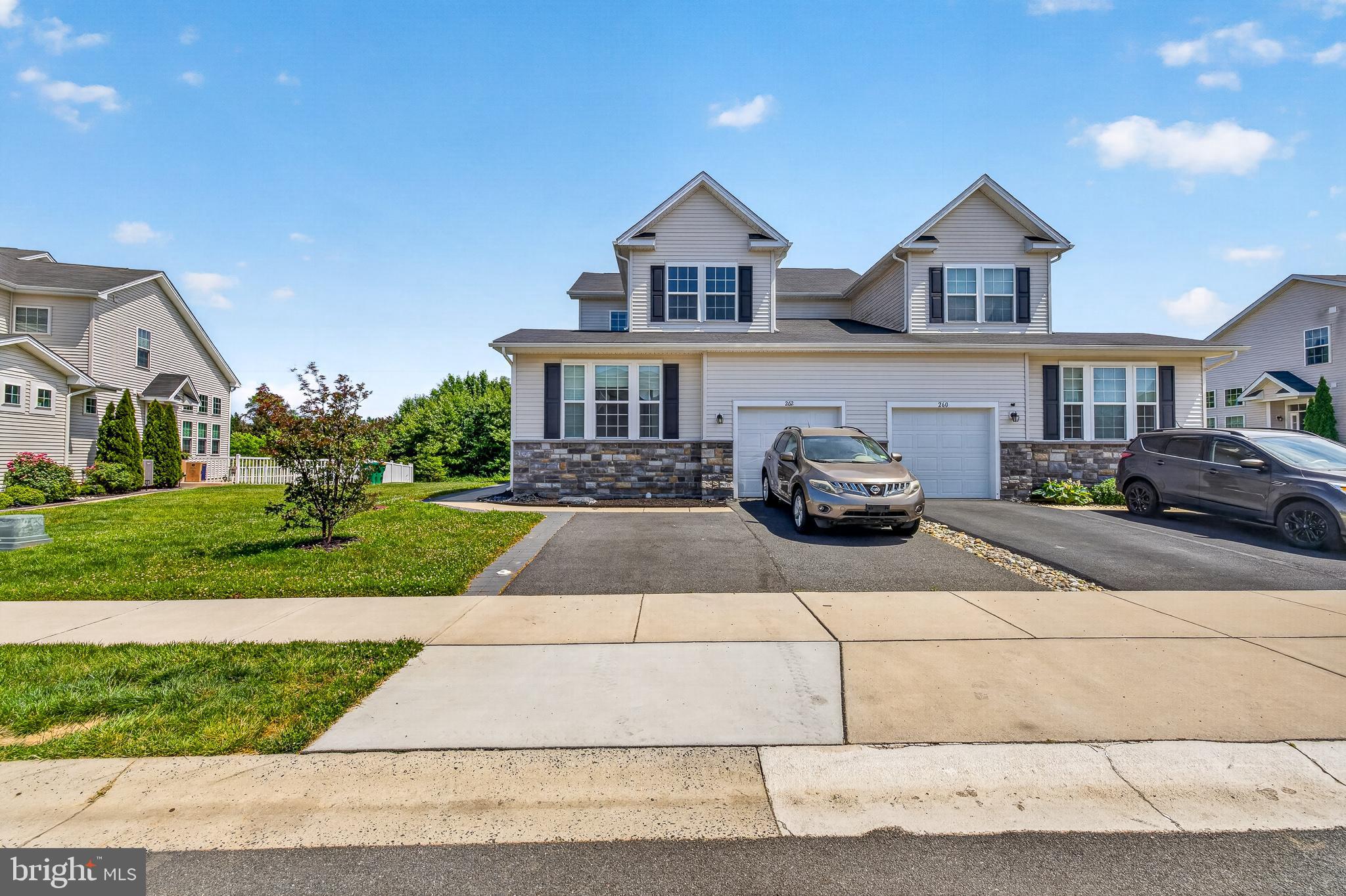 Welcome to 262 Rossnakill Road, a beautifully maintained and thoughtfully updated twin home located in the highly desirable Hyett's Crossing community.

As you arrive, you'll immediately appreciate the expanded driveway, providing parking for two vehicles. Step inside to discover a bright and inviting interior featuring hardwood flooring throughout the main level, recessed lighting, fresh paint throughout, and an open-concept floor plan designed for modern living.

To the right of the entryway, you'll find a convenient powder room and coat closet. The heart of the home is the impressive two-story living room, where large windows fill the space with natural light and a cozy gas fireplace creates the perfect setting for relaxing evenings or family gatherings.

The adjoining kitchen is both stylish and functional, offering granite countertops, stainless steel appliances, modern cabinetry, and a spacious center island with seating for four or more. The dining area flows seamlessly from the kitchen, making entertaining effortless.

Tucked away on the main level is a dedicated laundry room and the spacious owner's suite. Designed for comfort, the primary bedroom easily accommodates a king-sized bedroom set and features a large walk-in closet and an ensuite bathroom complete with a double vanity and walk-in shower.

Upstairs, an open loft overlooks the living room below and provides flexible space for a home office, reading area, playroom, or additional living space. Two generously sized bedrooms with ample closet space and a full hallway bathroom complete the second floor.

The basement offers additional living potential with a partially finished area ready for your personal touch, while the unfinished section provides excellent storage or future expansion opportunities. A two-piece rough-in is already in place for a future powder room.

Step outside to your own private retreat. The backyard features a built-in gazebo, creating the perfect setting for outdoor dining, entertaining, or simply enjoying the peaceful surroundings. With the homesite backing to alot of trees, you'll enjoy added privacy .

Residents of Hyett's Crossing enjoy access to more than 70 acres of preserved open space while benefiting from a convenient location near major routes connecting Wilmington, Philadelphia, Baltimore, and Delaware's beaches.

This move-in ready home combines comfort, space, and convenience in one exceptional package. Schedule your private tour today and experience all that 262 Rossnakill Road has to offer.