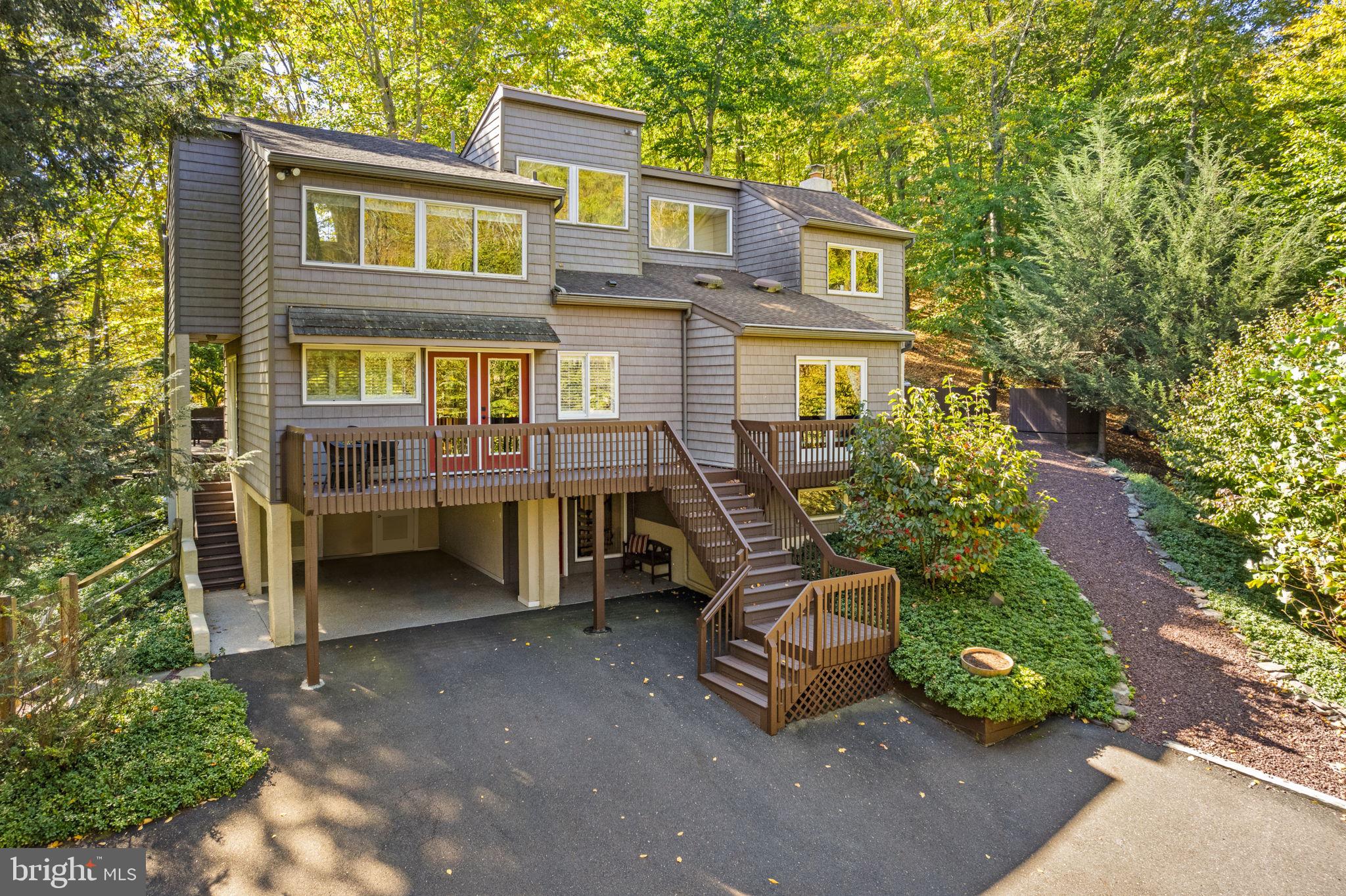 Experience serene beauty of wooded surroundings, picturesque views of the creek below and the soothing sounds of nature in this bright and open home. If you are looking for peace and tranquility, you will absolutely love the privacy yet still have convenient access to the Delaware River and less than 8 miles to the shopping, dining, and entertainment in coveted New Hope Borough. This truly unique home, boasting breathtaking views from every window, is meticulously maintained and is a rare find that seamlessly marries charm, character and modern comforts offering the true experience of Bucks County living. 4 generous bedrooms with 3 full baths boasting Carrera marble provide the ultimate in style and comfort.  Additional benefits include lovely hardwood flooring throughout, chic leathered granite in the Kitchen, wood-burning fireplace in the Gathering Room, whole house generator and a multitude of outdoor spaces to relax and unwind. Over $ 250,000 of recent improvements! Just a short drive to New Hope and Carversville which is the official post office box location! Be inspired by all that nature has to offer in your own private retreat.