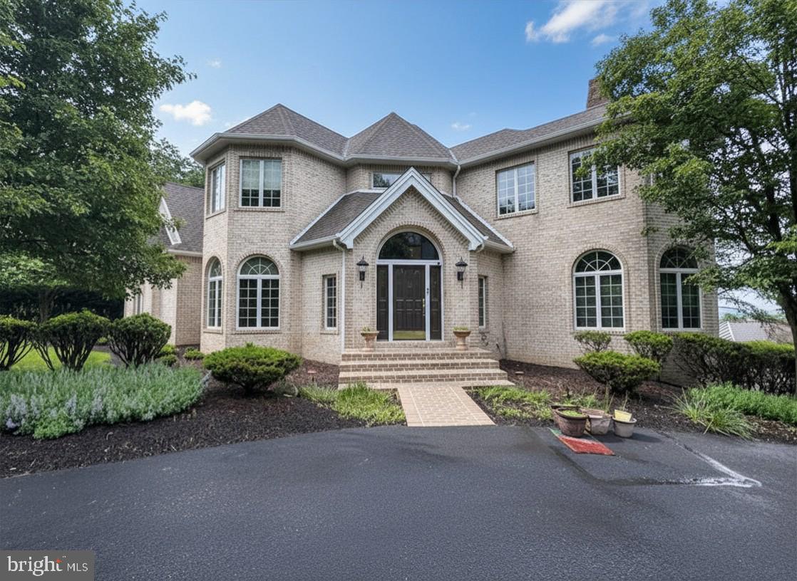 Perched on Blue Mountain with breathtaking views from the exquisite in-ground pool & entertainment area, upper deck  and primary suite, this remarkable all-brick Yingst luxury home blends a matchless vista with timeless craftsmanship and exceptional comfort. Offering over 6,400 square feet of beautifully finished living space, every detail was thoughtfully designed for both elegant entertaining and everyday living.
Inside, soaring 10-foot ceilings, rich hardwood flooring, and refined architectural details create a warm and sophisticated atmosphere. The formal living and dining rooms are perfect for hosting, while the expansive chef’s kitchen is complete with natural curly maple cabinets, granite island, additional vegetable sink, butlers pantry, separate dining area and built-in desk serves as the heart of the home. A bright sunroom with wet bar provides the perfect place to relax.
Upstairs, the luxurious primary suite features a tray ceiling and spa-inspired bath with soaking tub, alongside three additional bedrooms, two full baths, and an exercise room. The finished walk-out lower level adds even more living space with a cozy family room, custom bookshelves, additional bedroom suite offers privacy and flexibility for guests or multi-generational living, and wine cellar.
Outside, the home transforms into a private retreat with a wraparound deck overlooking the valley, a custom heated saltwater pool, and a custom pavilion with outdoor kitchen designed for unforgettable gatherings. With a new roof, new carpeting, solid wood doors, rear-entry 3-car garage, and countless additional upgrades throughout, this is more than a home, it’s a lifestyle. A joy to own.