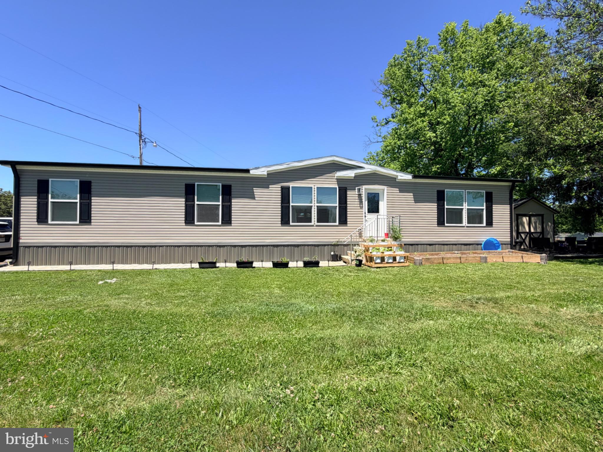 Why wait for new construction when you can move right into this beautifully maintained 2025 manufactured home? Offering 5 bedrooms, 2 full bathrooms, and over 1,500 square feet of living space, this home combines modern style, functionality, and affordability.

The thoughtfully designed open-concept floor plan features a spacious living area that flows seamlessly into the large eat-in kitchen and dining area, creating the perfect space for everyday living and entertaining. The kitchen offers abundant cabinetry, upgraded finishes, decorative accents, and a generous pantry for additional storage. A dedicated laundry area adds convenience and practicality.

The spacious primary suite provides a private retreat with an en-suite bath, while four additional bedrooms offer flexibility for family, guests, a home office, or hobby space. Throughout the home, you'll find upgraded ceiling fans, attractive built-ins, fresh paint, and stylish finishes that enhance the home's modern appeal.

This move-in-ready, meticulously maintained, home offers the space you need with the updates you want. Conveniently located near shopping, dining, schools, and commuter routes. You must be accepted to the Harlan Springs park in order to purchase the home. Lot rent applies.