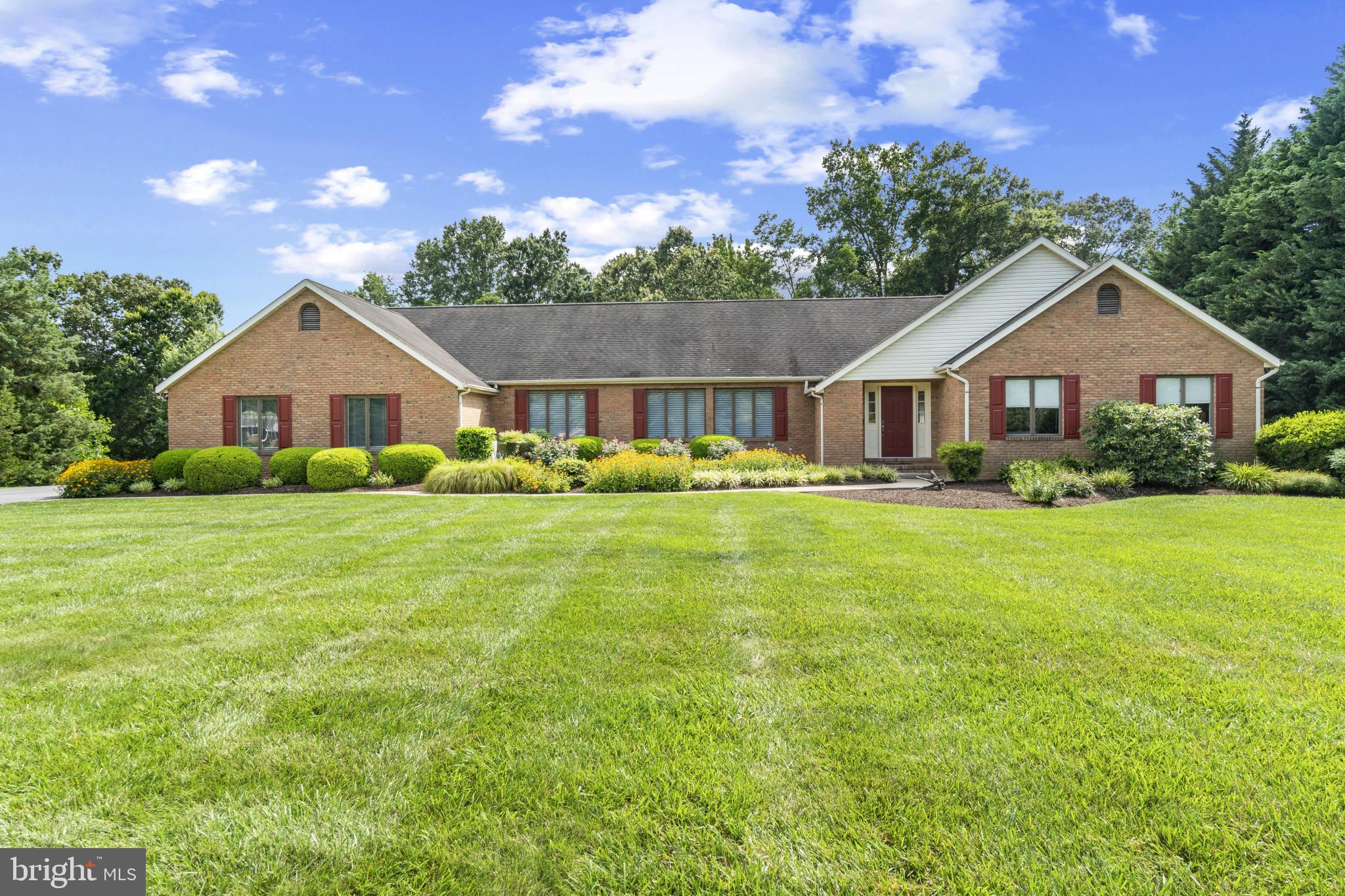 Located in the highly desirable Governor Grason Manor neighborhood, this beautiful Wye River waterfront home embodies Eastern Shore living at its finest. Situated on 1.84 acres, this 2800 sq ft, one-level-living home has room for everyone, and the extensive decking and screened-in porch offer lots of entertainment options. The spacious primary suite offers water views and is complemented by its large California Closet walk-in and a generous ensuite with walk-in shower. Two guest bedrooms and a full bathroom are down the hall. The fourth bedroom/office with custom millwork/built-ins is on the opposite side of the home, with an adjacent third full bathroom. Bright, natural sunshine reaches throughout the home, while custom motorized blinds keep it out when desired. Gourmet kitchen w/quartz counter tops, Brighton cabinets, stainless appliances, and gas range lead into the screened porch with gorgeous water views. Custom millwork
and shelving are found throughout the living areas. The home features extensive storage throughout, and the heated and air conditioned garage is simply amazing, featuring built-in shelving and storage, epoxy coated flooring, and even a Tesla 220v charger built in. The exterior is beautifully landscaped to ensure color year-round. With a shoreline of 256’, and a protected pier with 3-4’ MLW, this home provides endless waterfront activities, beautiful views, and immediate access to the Wye River. A true Eastern Shore classic!