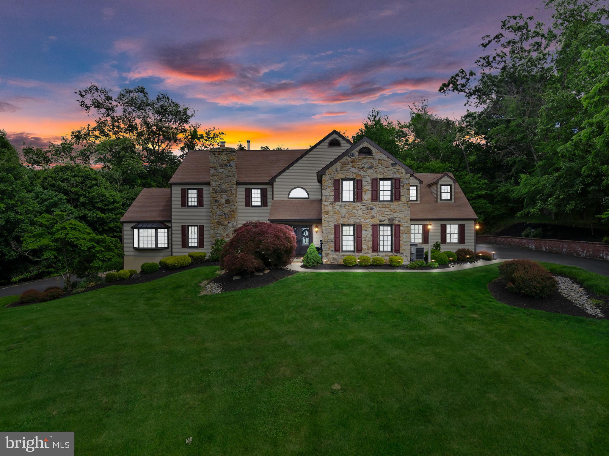 Welcome to 500 Deerfield Lane, an extraordinary luxury estate nestled on over 10 breathtaking acres in the heart of Doylestown. Featured in Delaware Valley Living Magazine for its exceptional renovation and design, this one-of-a-kind contemporary chalet masterfully blends timeless elegance, architectural character, and modern luxury to create a truly unforgettable residence.

From the moment you arrive, the home’s stunning setting and meticulously curated landscape establish a sense of privacy and grandeur rarely found in today’s market. Thoughtfully reimagined with exceptional craftsmanship throughout and over 5,000 square feet of livable space, this home has been designed to offer both sophisticated entertaining and comfortable everyday living.

At the heart of the home is a spectacular chef’s kitchen where custom-built cabinetry, granite surfaces, premium appliances, and striking exposed stone archways create an atmosphere of warmth and refinement. The custom archways seamlessly connect the kitchen, dining, and living spaces, creating an effortless flow ideal for gatherings both intimate and grand.

The dramatic living room serves as a showpiece of the home, featuring rich hardwood flooring, custom-built entertainment cabinetry and shelving, elegant ironwork detailing along the staircase and upper gallery, and a stunning wood-burning stove framed by an extended fireplace and custom mantel. Soaring ceilings, designer lighting, and carefully selected finishes create a space that is both inviting and impressive.

A beautifully appointed home office offers custom cabinetry and a picturesque bay window overlooking the estate’s expansive grounds, providing a tranquil and inspiring workspace. The fully renovated lower level expands the home’s living and entertaining capabilities with an impressive recreation area, custom bar, dedicated fitness room, generous storage, and updated finishes throughout.

The luxurious bedroom suites have been thoughtfully enhanced with custom built-ins, integrated speaker system (primary bedroom) and inviting sitting areas, creating private retreats designed for comfort and relaxation. Spa-inspired bathrooms offer a resort-like experience with elegant finishes and timeless design.

Step outside to discover your own private resort. The expansive deck, constructed with premium Hardie Board planking, overlooks a stunning saltwater pool surrounded by extensive custom hardscaping and mature landscaping. Whether hosting summer gatherings, enjoying peaceful mornings, or unwinding beneath the stars, the outdoor living spaces offer a level of serenity and sophistication that is simply unmatched.

Additional highlights include newer windows, integrated audio features, custom garage storage systems, a heated three-car garage with workshop space, abundant additional parking, and enrollment in Act 319, offering potential tax advantages. Every detail has been thoughtfully considered to enhance both beauty and functionality.

Located within the highly desired Central Bucks School District and just minutes from historic Doylestown, New Hope, Peddler’s Village, award-winning dining, boutique shopping, and convenient access to Philadelphia, New York City,  airports, local train stations and beyond, this remarkable estate offers a rare opportunity to experience luxury living in one of Bucks County’s most coveted settings.

500 Deerfield Lane is more than a home—it is a private sanctuary where elegance, craftsmanship, and natural beauty converge.