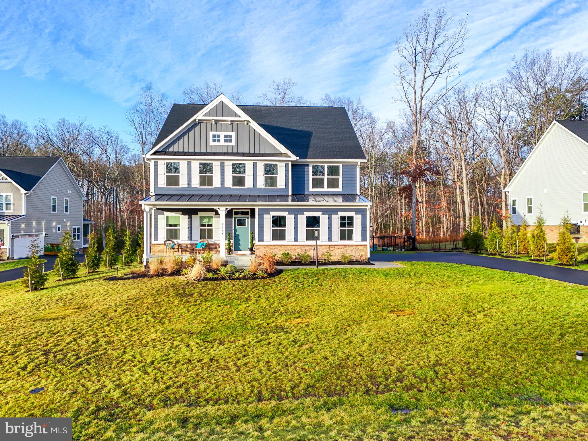 Discover an incredible opportunity to own a stunning modern craftsman in the prestigious gated Fawn Lake community. Built in 2022, this home sits on a desirable cul-de-sac lot backing up to a wooded conservation area, providing a secluded and tranquil setting. Meticulously designed with a bright, open floor plan, this home offers a perfect blend of space and sophistication.  A welcoming front porch leads to a versatile flex room that seamlessly transitions into a formal dining space, ideal for elegant gatherings.  The heart of the home features a family room that flows into a dining area and a gourmet kitchen, complete with an island for casual dining and a covered porch for alfresco entertaining. The layout includes a convenient entry off the two-car garage with a spacious mudroom, half bath, and a flexible space ideal for a home office.  Upstairs, you will find four spacious bedrooms, including the opulent primary suite designed as a private retreat with a spa-like bath featuring double sinks and dual spacious walk-in closets.  The finished basement adds another dimension to this home, featuring an additional bedroom and bath, a home gym, a den, and extra storage space, all with easy access to the expansive, fenced-in backyard.  Live with ease in this well-appointed, beautifully designed home that promises a lifestyle of comfort, convenience, and luxury. The beautiful gated community of Fawn Lake offers an unparalleled luxury lifestyle with exceptional amenities, including a recreational boating lake, sandy beach, community pool and clubhouse, renowned Arnold Palmer golf course, tennis and pickleball courts, soccer and baseball fields, miles of scenic walking trails, a dog park, marina, on-site restaurants, playgrounds, and a variety of clubs and activities for all ages. Experience the ultimate in resort-style living and make every day feel like a vacation!