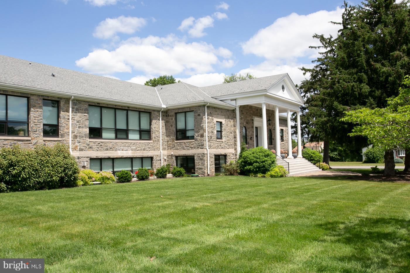 Welcome to STONESCHOOL, where History meets Luxury. A Spectacular SECOND FLOOR unit that offers spacious and beautiful one-floor living.  Entry Foyer with authentic chalk board from the original school.  Lockers for coats and storage, and large powder room.  Be amazed as you turn the corner and enter the Large  Open Living Area with oversized windows with deep window sills , 11 ft high ceilings, Gleaming Hardwood Floors, Gas fireplace and custom built shelving.  Original wood doors from school  located throughout  bring  a unique and historical feel.  Imagine Cooking in the  Gourmet Kitchen with quartz counters , custom cabinetry, and top of the line appliances. Also boasts a  Large Island with plenty of seating and storage,  custom built bar with glass cabinetry, double oven, and  gas cooktop with  industrial  style rangehood.  A Chef's Dream Kitchen!  Primary Suite with a large walk-in closet , Full Bath with Marble floors and  Custom tiled shower, with frameless shower door  and shelving built-in  for toiletries.  Second bedroom with full bath and  walk-in closet.  Third room can be used as bedroom/office/den, and also has a large closet. Laundry room with cabinetry, laundry tub  and storage room .  Custom window treatments throughout.  This unit also has first floor storage room.  Along with this outstanding, pristine Unit are The   STONESCHOOL Amenities that are included -  Community Room with bar, games and pool table,  great for parties and gatherings.   Craft /art room,  Fitness Center,  Outdoor Picnic/barbecue area with firepit and plenty of seating,  Dog park, Community garden and walking trail.    This unit is in the most desired location  -  Close to parking, and all the Stoneschool amenities! The Entire community is surrounded by truly lavish landscaping.  Carport and lot,  2 spots for each unit.  Security system entry.   The convenient location to shopping, restaurants  and parks is priceless.  A truly Unique and Spectacular Home! Carefree Living at It's Finest!