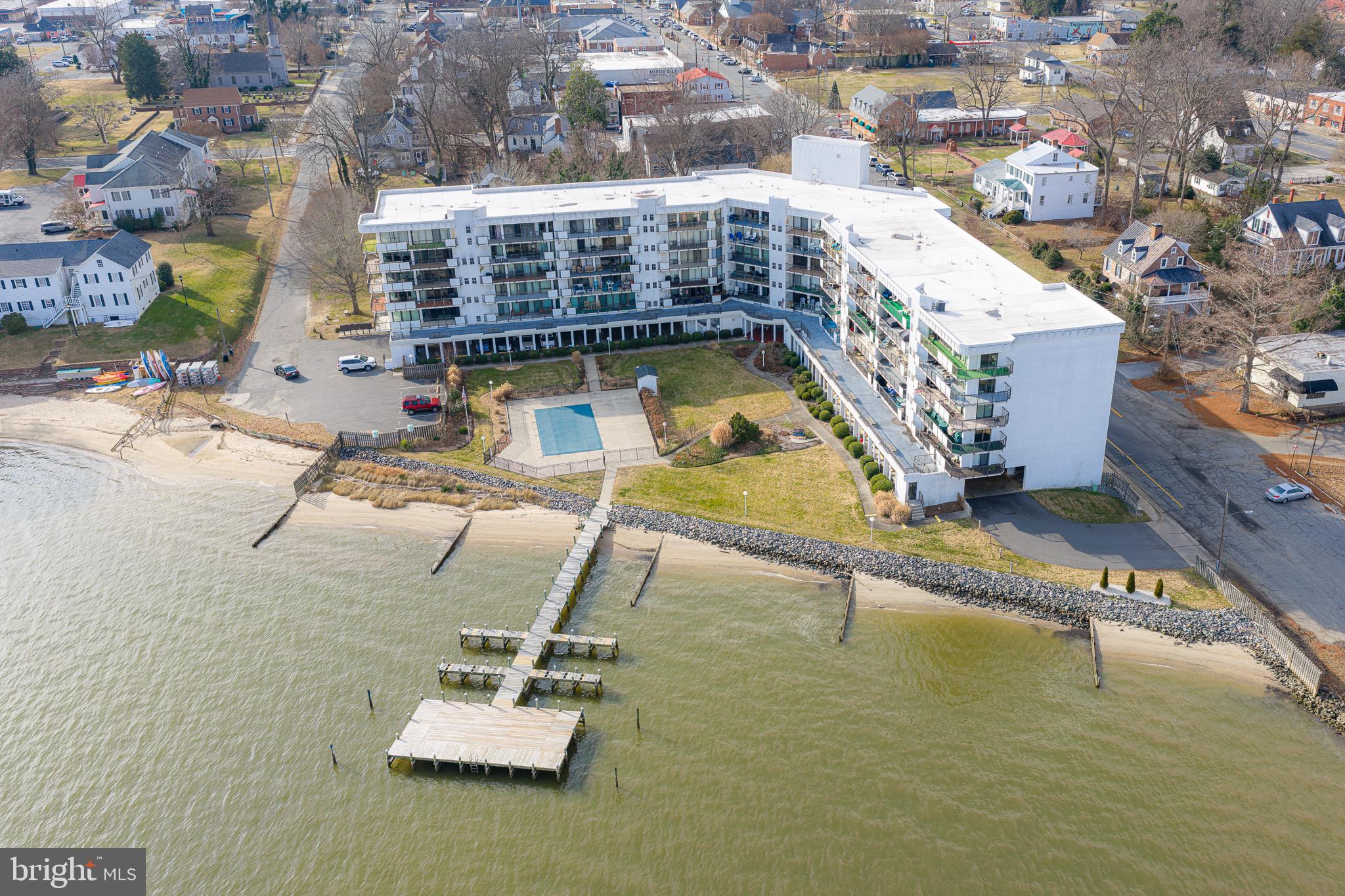 Experience effortless waterfront living at The Riverside, where panoramic views of the Rappahannock River greet you from the moment you step inside! This move-in-ready 3 bedroom, 2 full bath condo has been thoughtfully updated throughout, featuring an updated kitchen and bathrooms, new flooring, upgraded windows and doors, and beautifully crafted built-ins that enhance both function and style. Floor-to-ceiling windows and a wrap-around balcony offering year-round riverfront scenery. Residents of The Riverside enjoy secure building access, covered parking, private storage, a community pier, private pool, and an inviting Party Room perfect for gatherings. The HOA fee includes water, sewer, exterior maintenance, basic cable, and trash pickup. Perfectly situated in the heart of Tappahannock, this condo combines convenience, comfort, and breathtaking views. Waterfront living has never been easier!