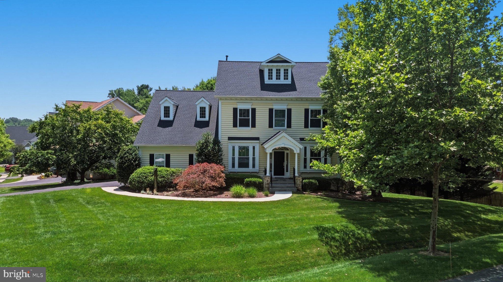 Welcome to this stunning Citation model Colonial-style home, boasting an impressive 3,829 square feet of meticulously designed living space featuring four spacious bedrooms and three and a half baths. From the moment you step into the welcoming entry, the home’s exceptional craftsmanship is on full display, highlighted by elegant wainscoting, crisp crown molding, rich hardwood floors, and soaring high ceilings. Large picture windows flood the interior with natural light, creating a bright and airy ambiance throughout. The main level seamlessly blends sophistication and comfort, offering a private, large home office complete with custom built-in library shelving, alongside a grand family room featuring a cozy gas fireplace and custom built-ins. This inviting space flows effortlessly into the gourmet kitchen, a chef’s dream equipped with premium quartz countertops, stainless steel appliances, a gas cooktop, and a double wall oven.
The upper levels provide a serene retreat, anchored by a luxurious master bedroom suite that features an expansive, room-sized walk-in closet. For ultimate convenience, the dedicated laundry room is also located on the second floor. The fully finished walk-out basement vastly expands the home's living space, offering a massive recreation room, a full bathroom, and an abundance of discrete storage space. Outside, the private brick patio provides an idyllic setting for outdoor dining, entertaining, or quiet relaxation. Completing this exceptional property is a large, two-car attached garage outfitted with durable, protective floor tiles, making this magnificent colonial a perfect blend of luxury, functionality, and timeless style.